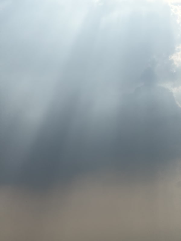 Beams of light shooting down in the sky