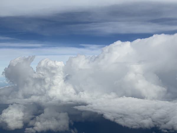 Thick fluffy clouds under a clear blue sky