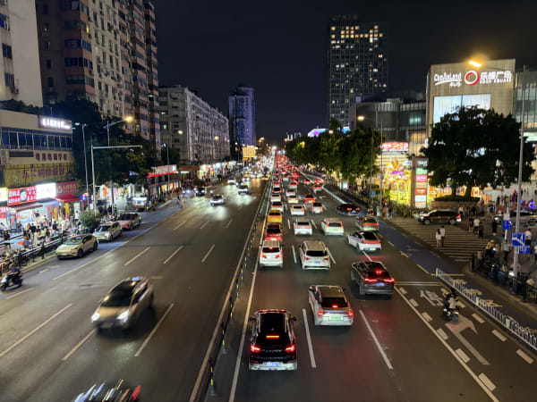 Stream of automobiles under a dark night sky