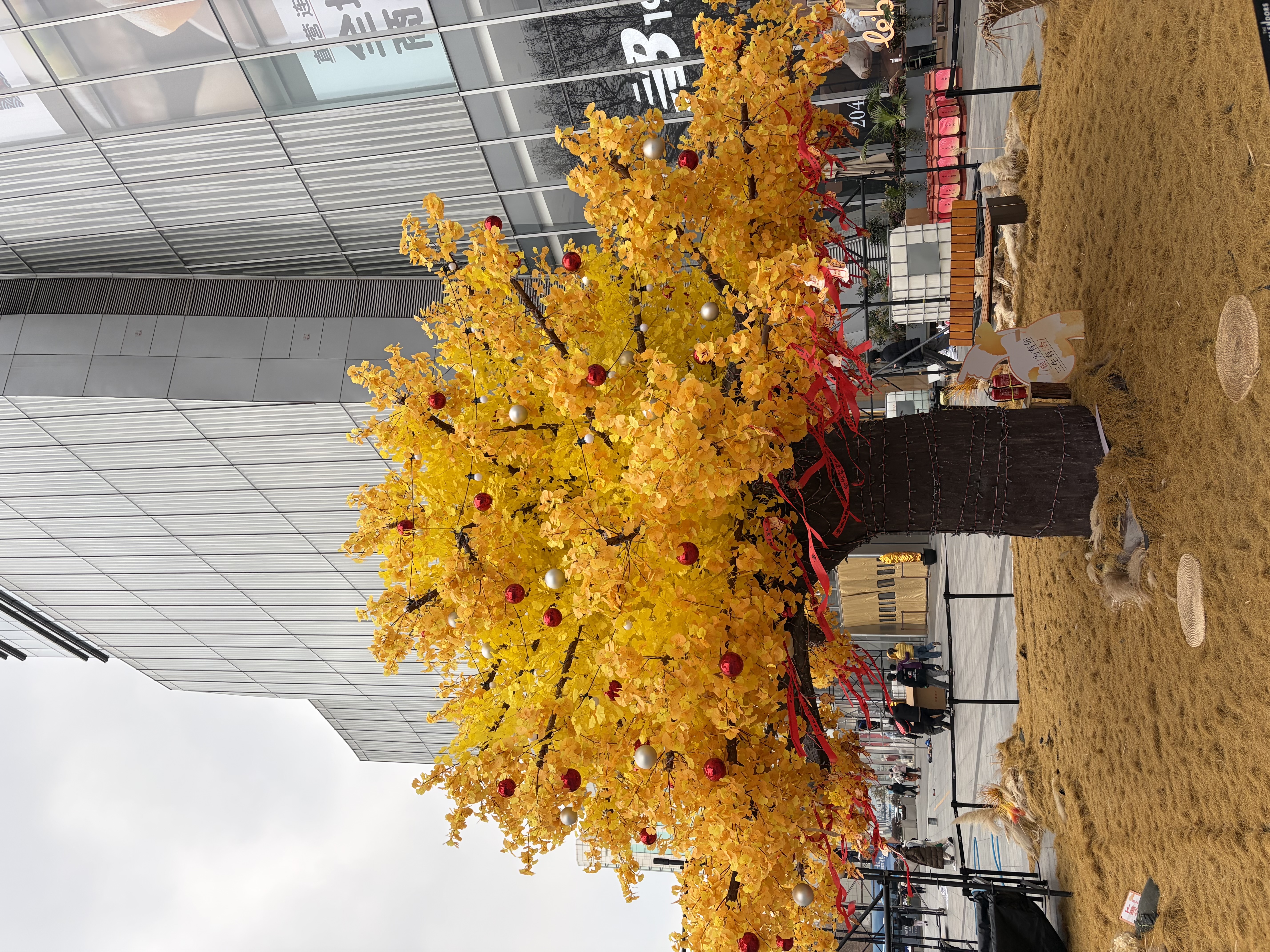 A golden tree with red and white balls hanging on it