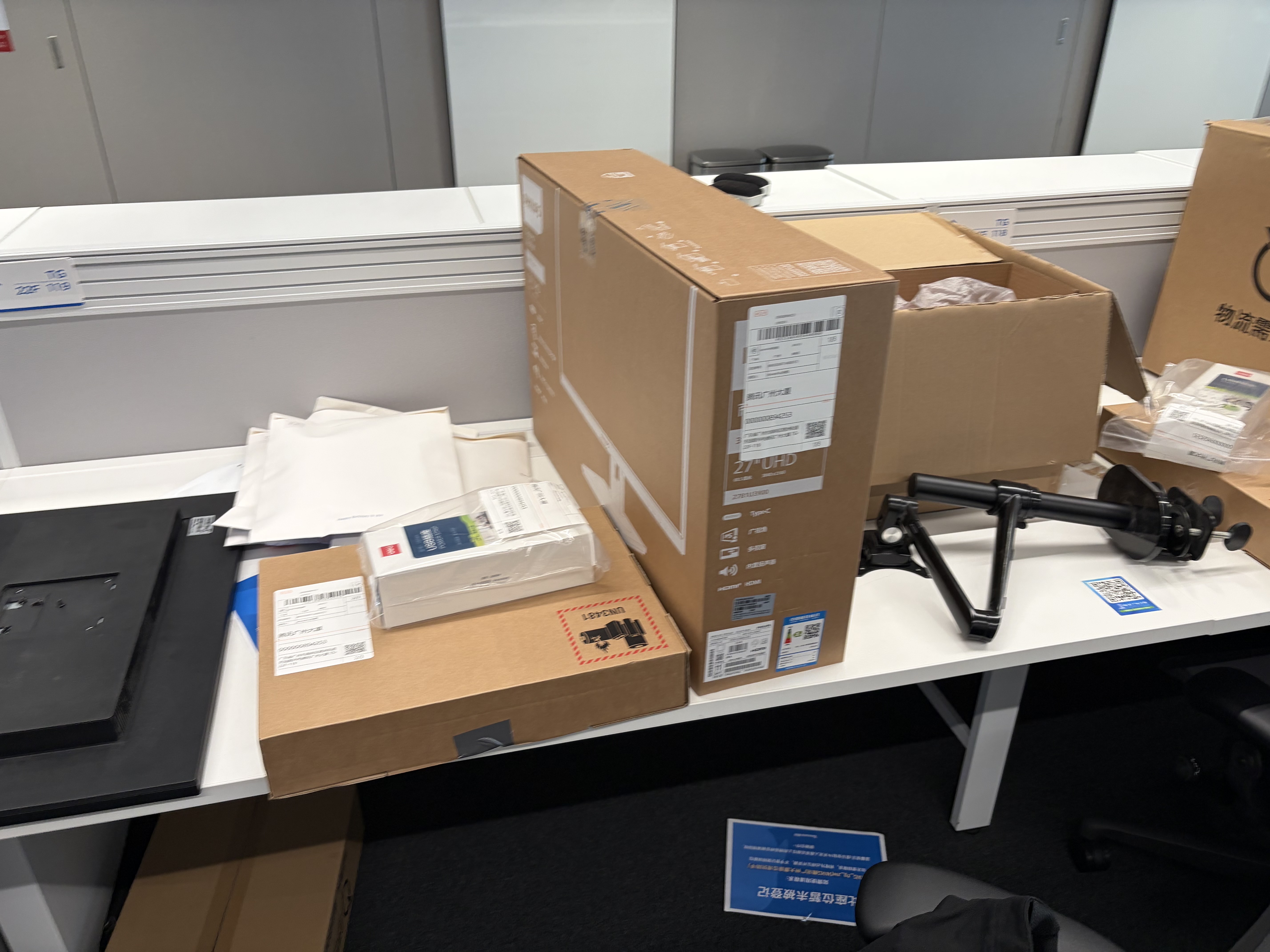 Boxes laying around on an office table, varying in size.