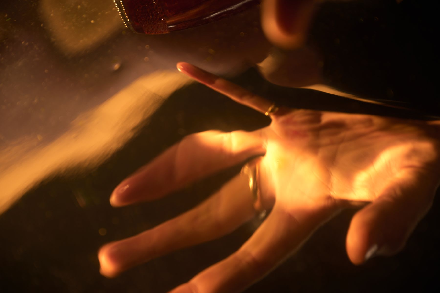 A white person's hand with fingers oddly distorted