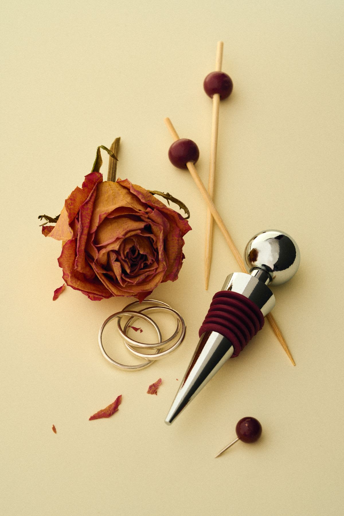 a dried rose and a wine bottle stopper are among items grouped together