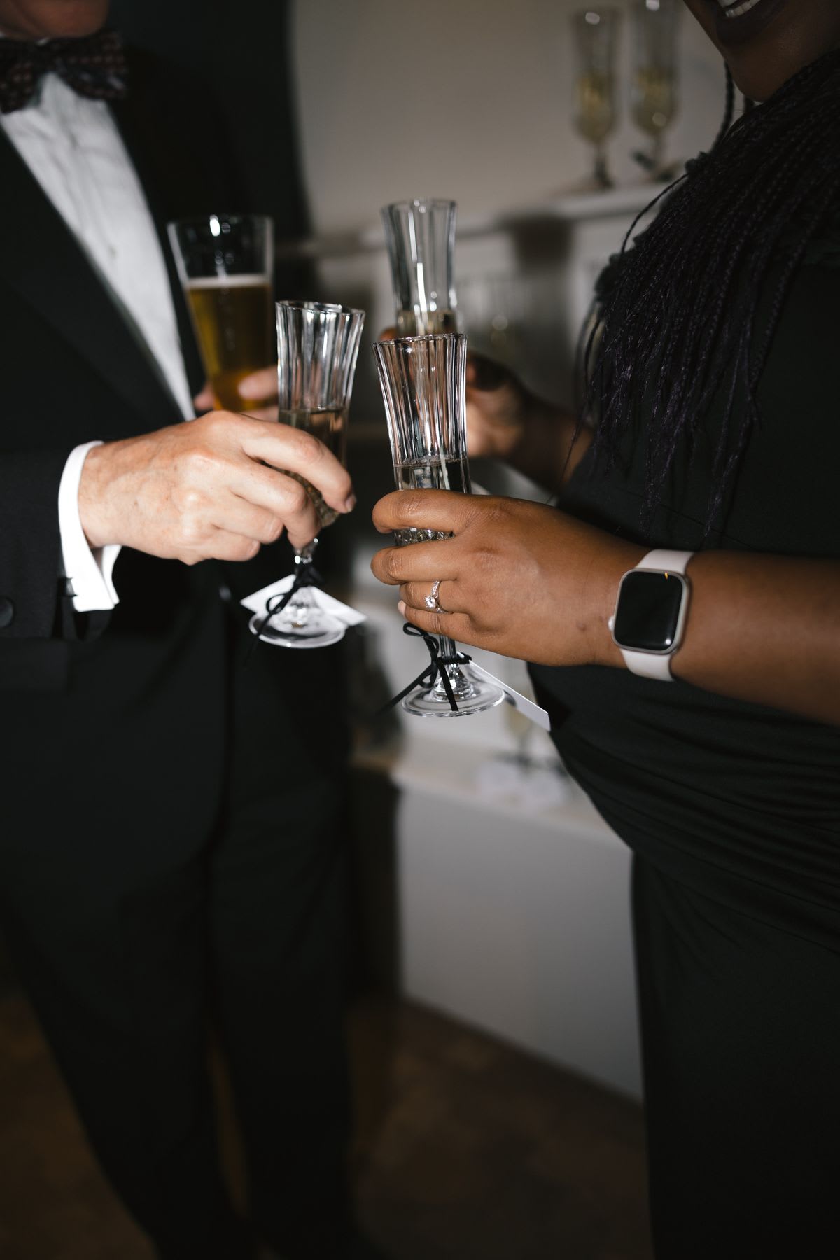 Man and woman standing together holding their drinks and socializing