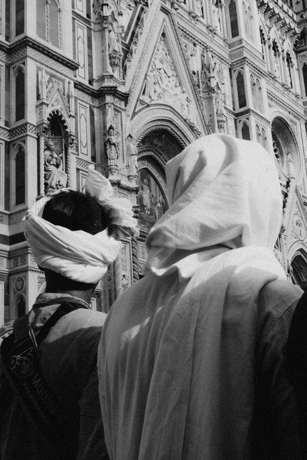 Two middle-easterners outside a cathedral.
