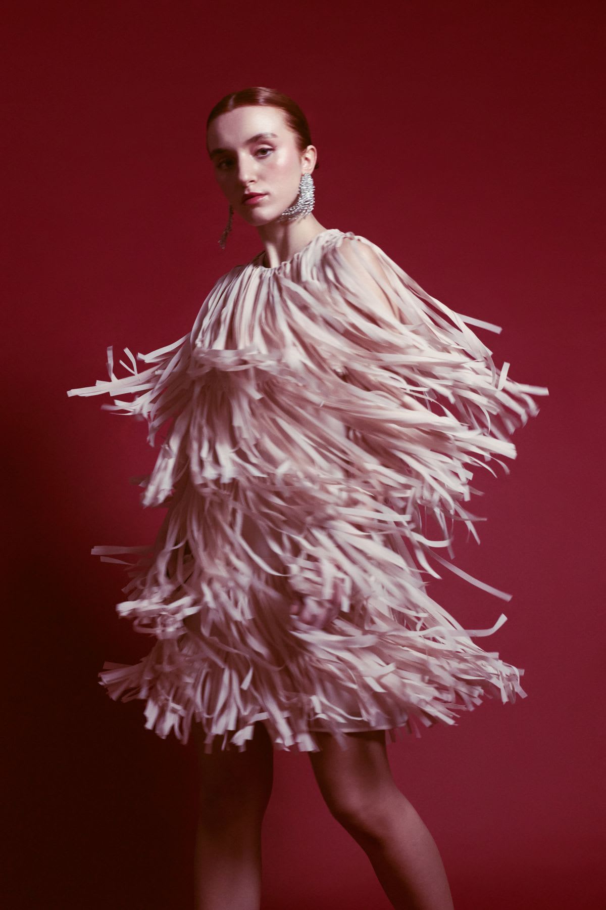 a model is wearing a dress that looks like a car wash brush