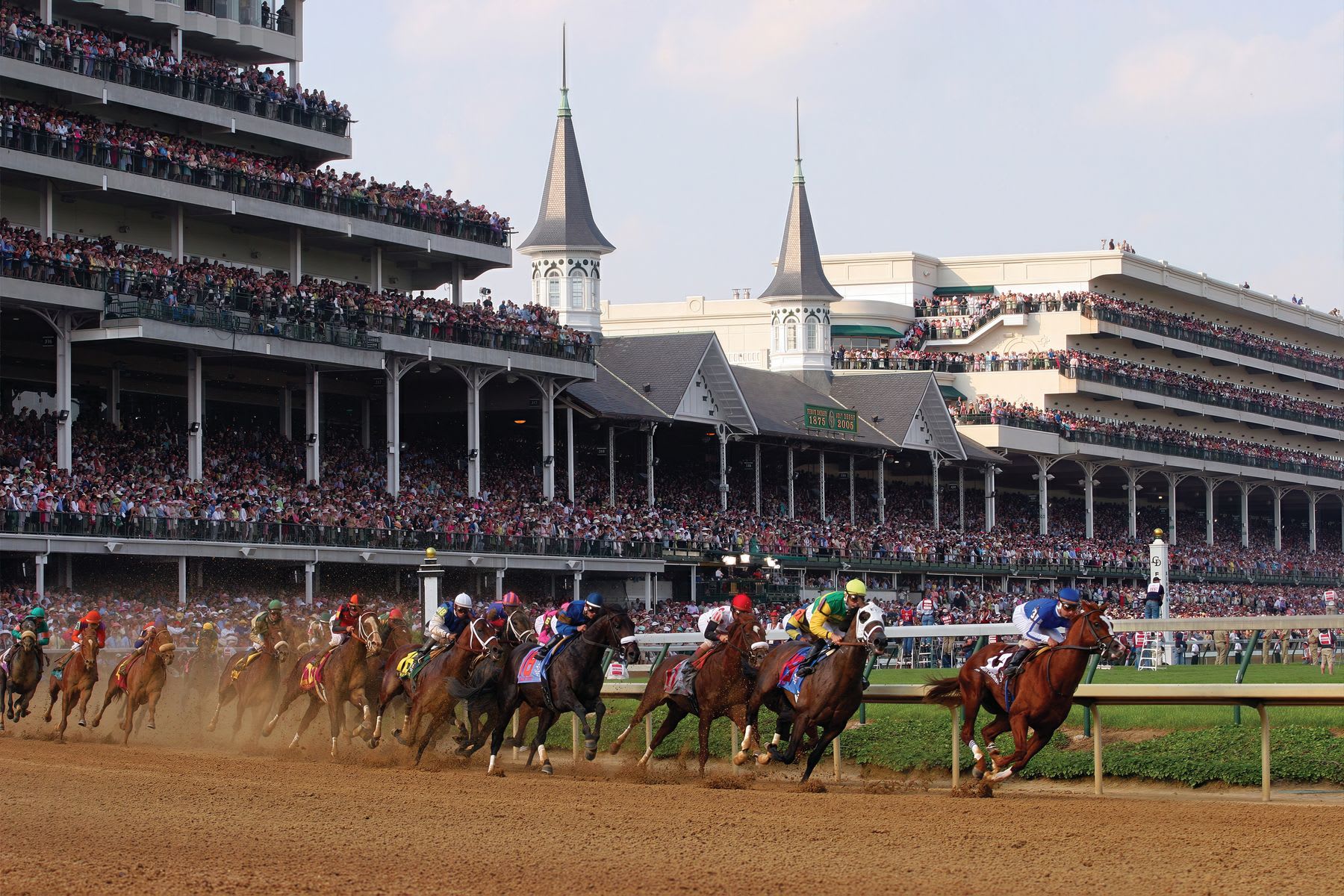 Crowd in a stadium watching horse racing