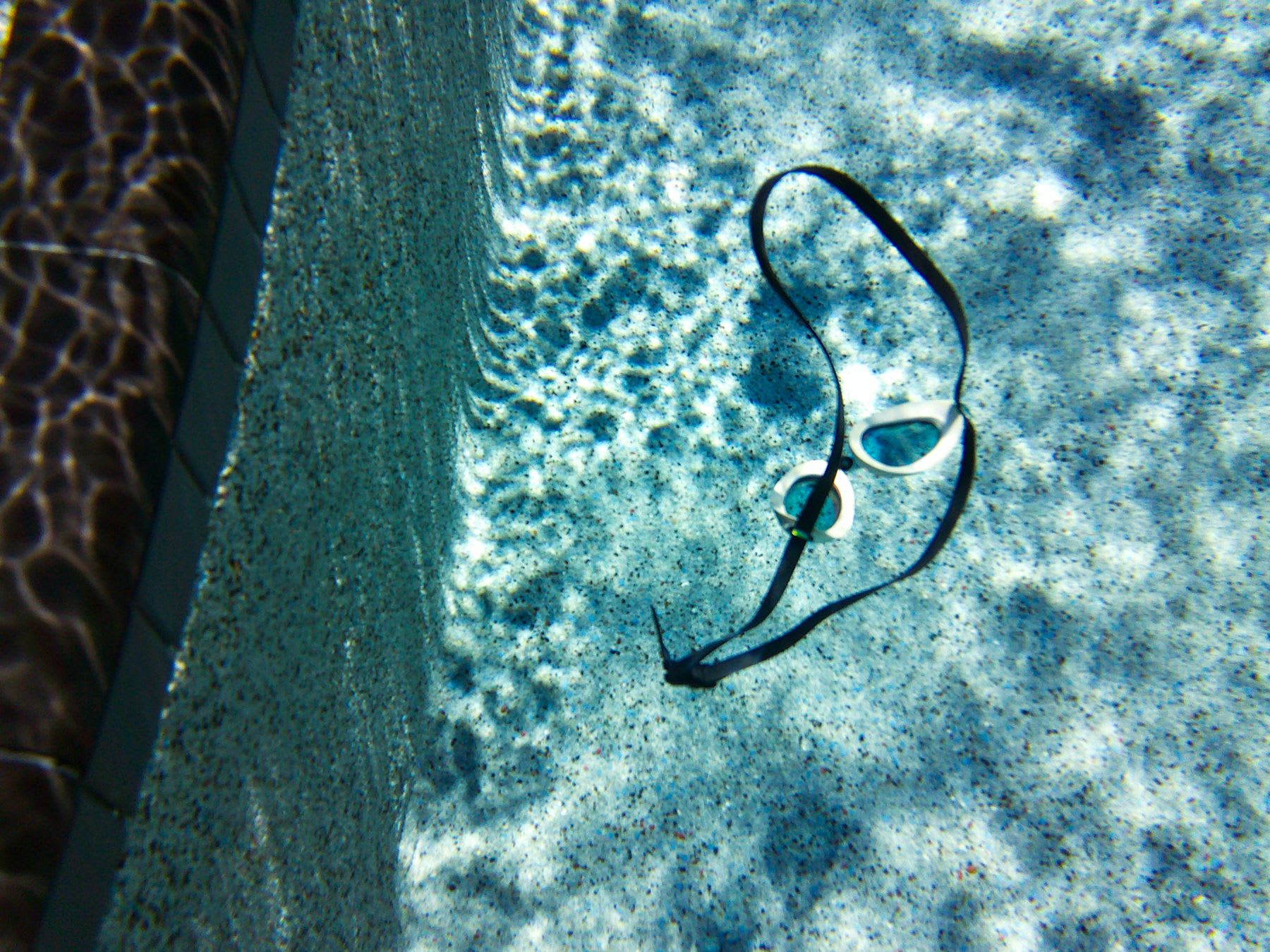 googles floating in a pool