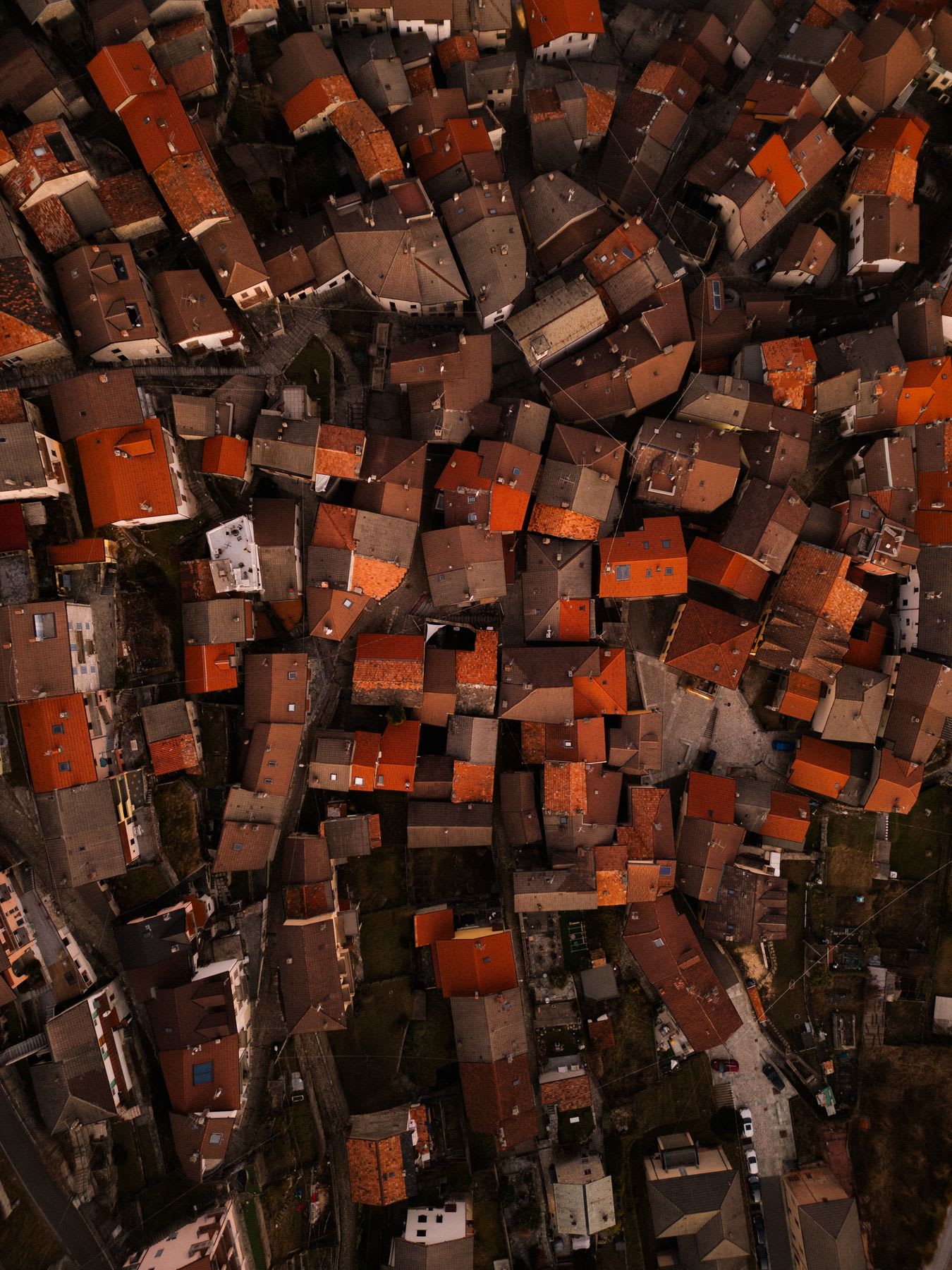 An aerial view of close buildings in a city.