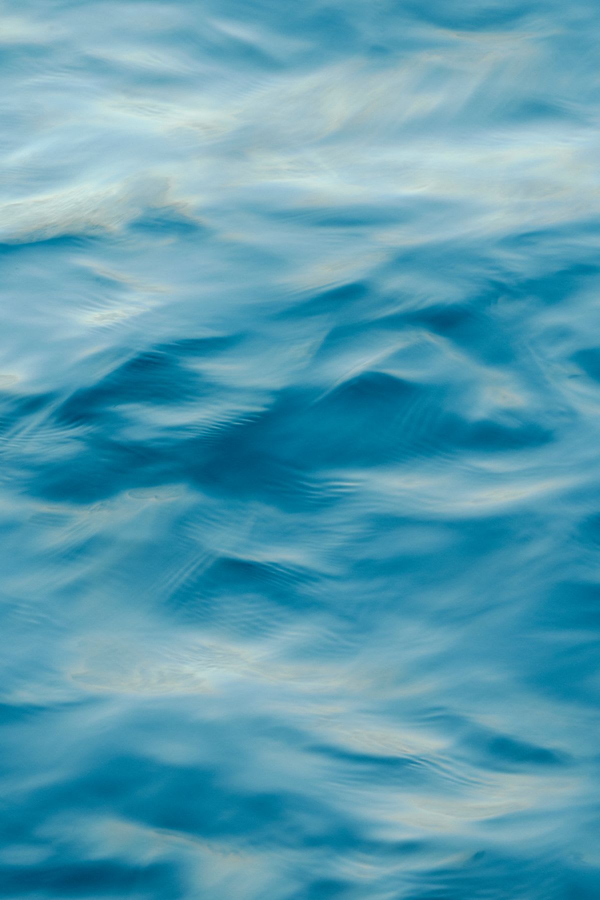 abstract water surface, with shades of blue swirling and blending to form a dynamic and ethereal pattern