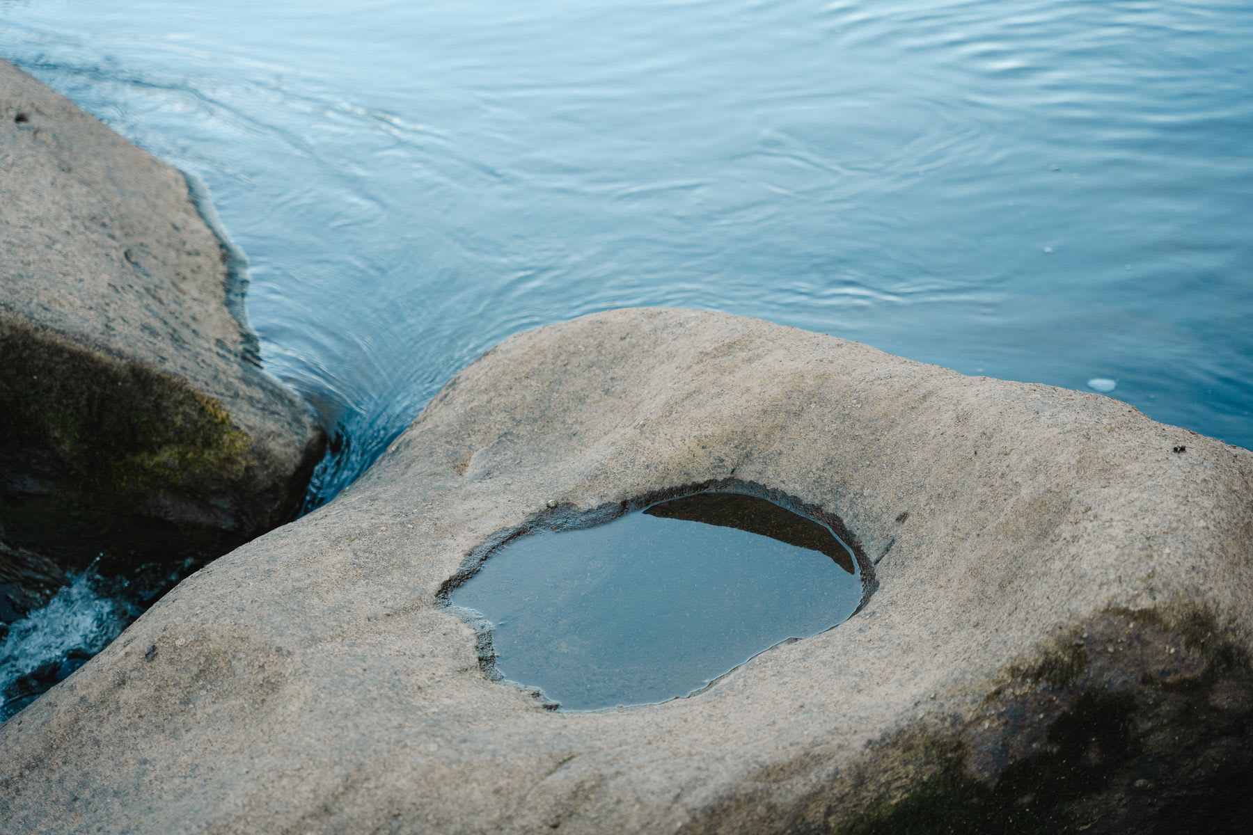 a very small stream in between two rocks flowing