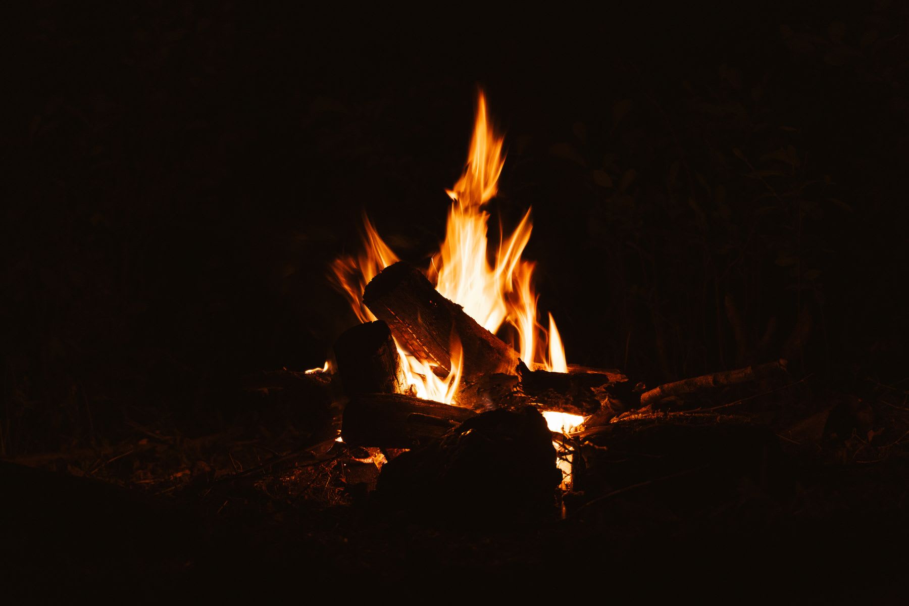 Bonfire lit in an outdoor area at night