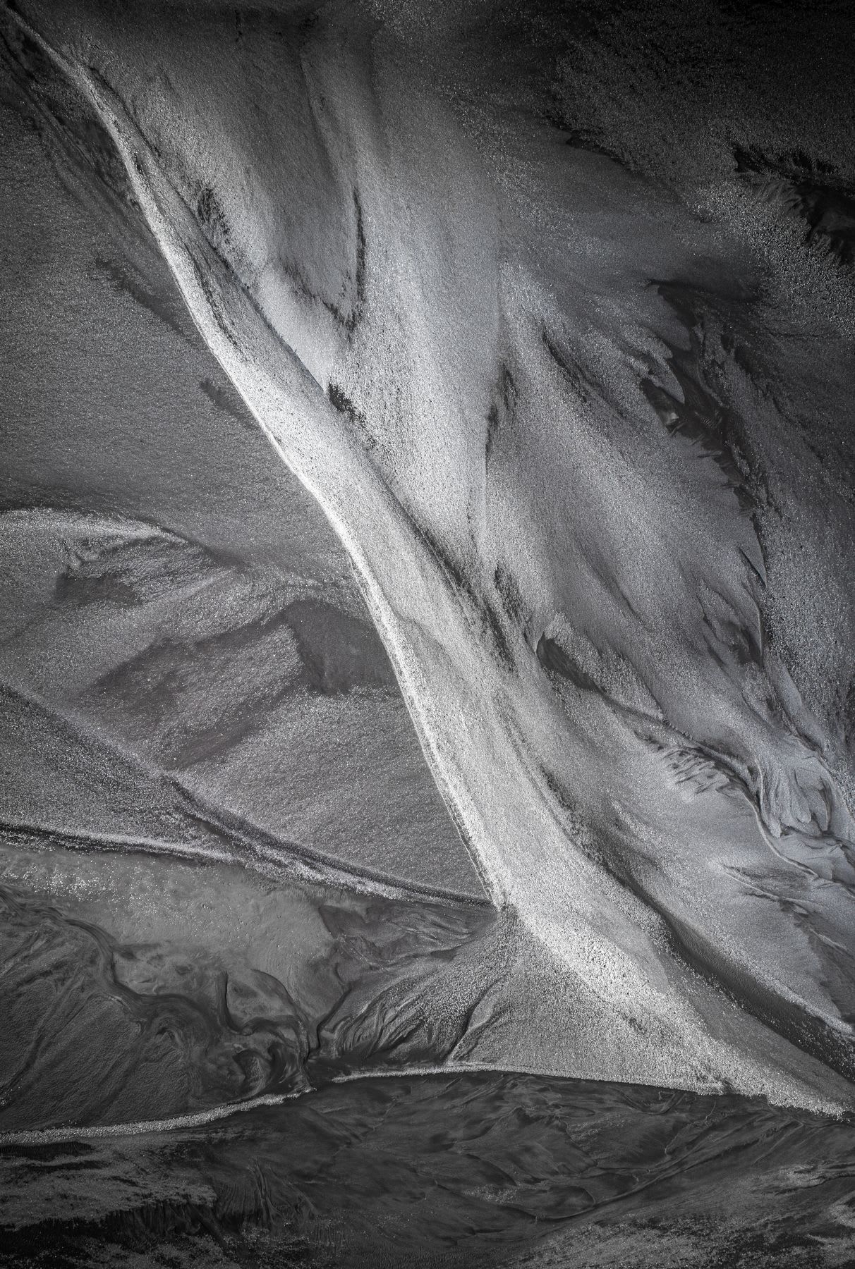 From above, windblown desert sands bridge the gaps between life-giving rivers