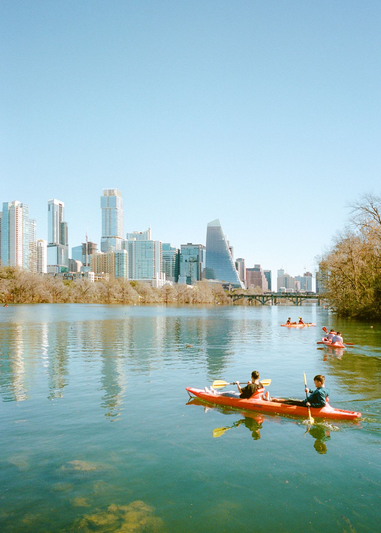 A group of people paddling canoes on a lake
