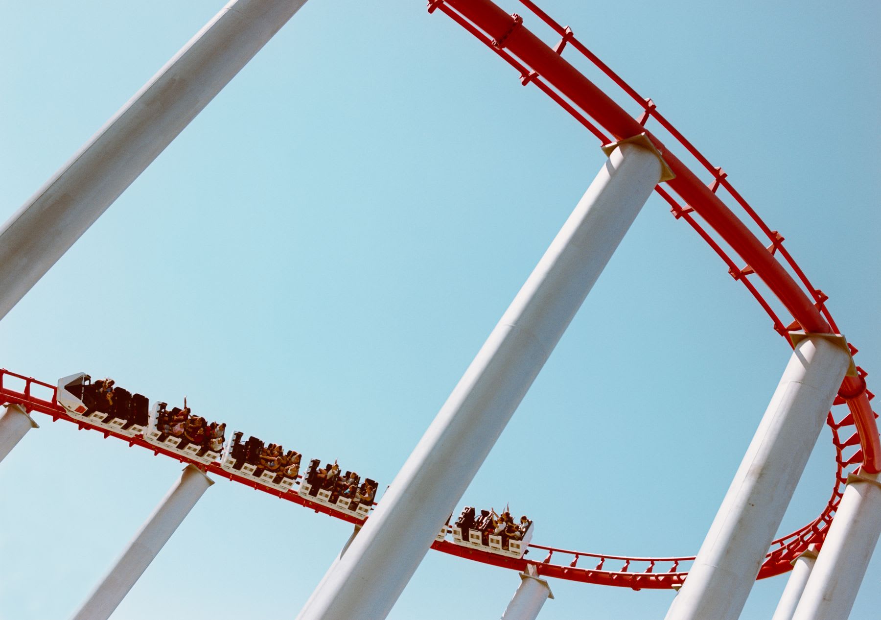 People riding a rollercoaster around a high curve