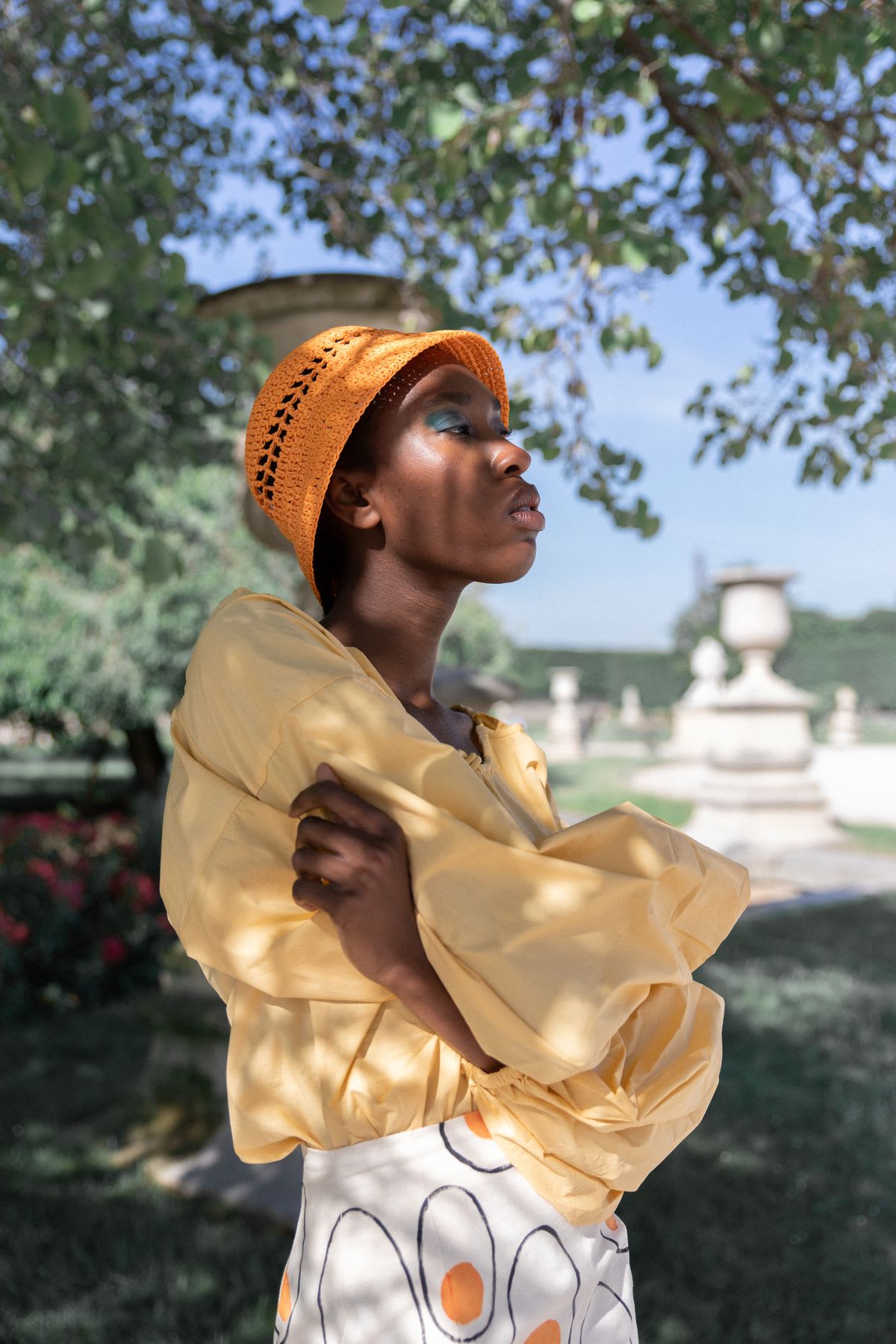 a woman is wearing an orange shirt and frilly shirt