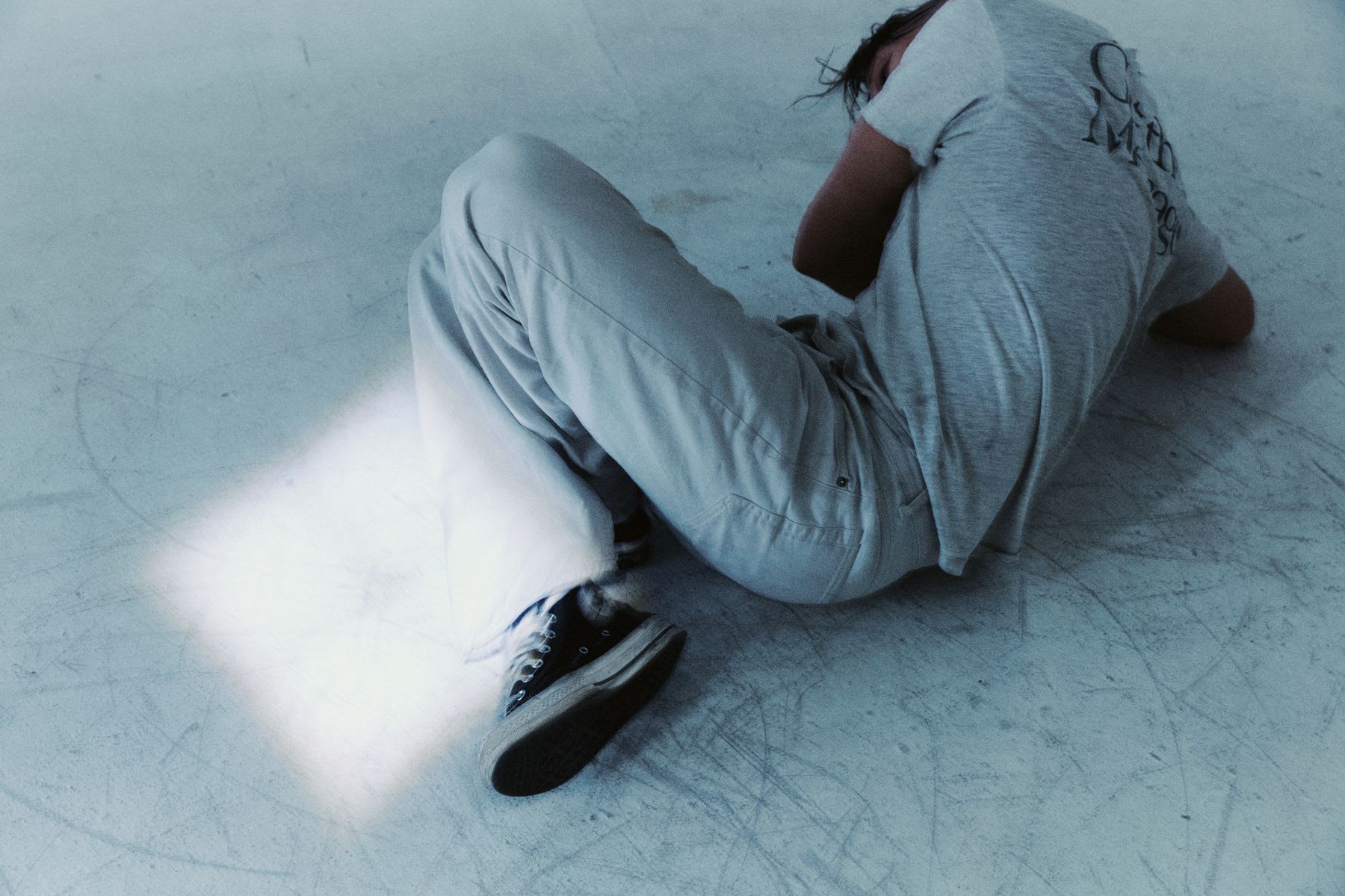 A person lying down on a light-colored surface.