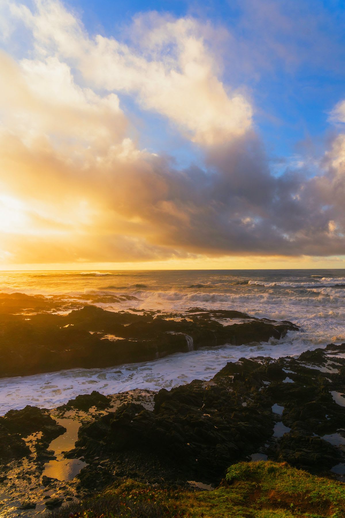 a fiery red sun dips below the horizon, casting a warm glow over the rippling waves of the ocean.