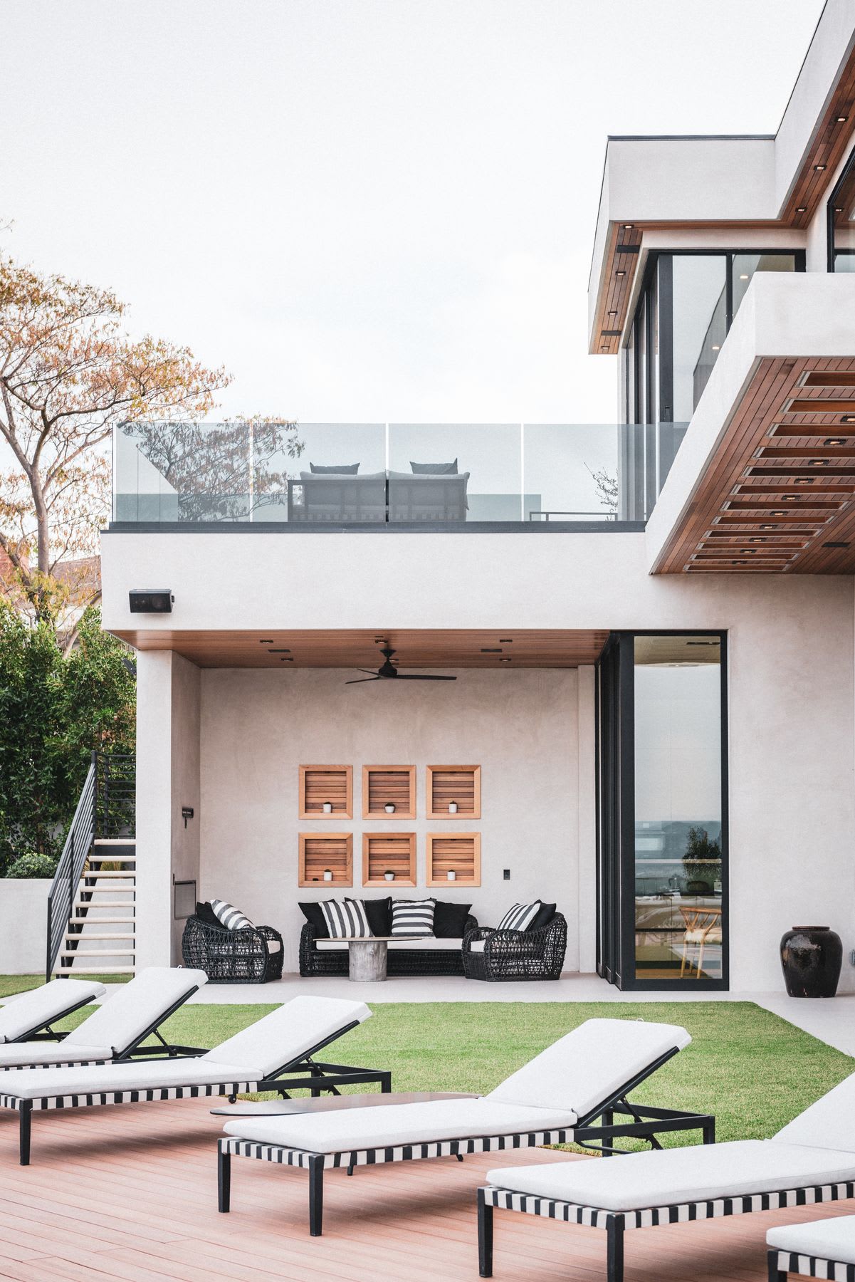 Apartment building with a balcony and chairs on the patio