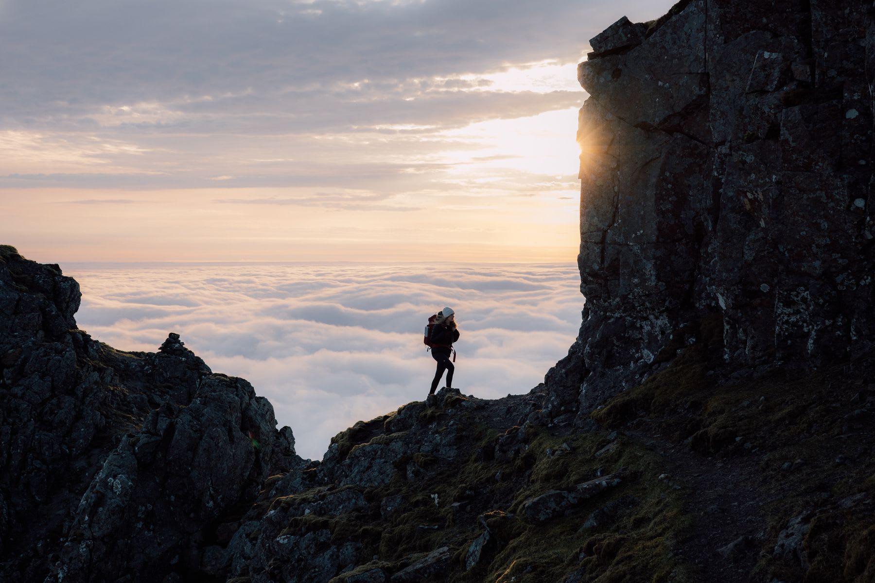 A person climbing up on a mountain