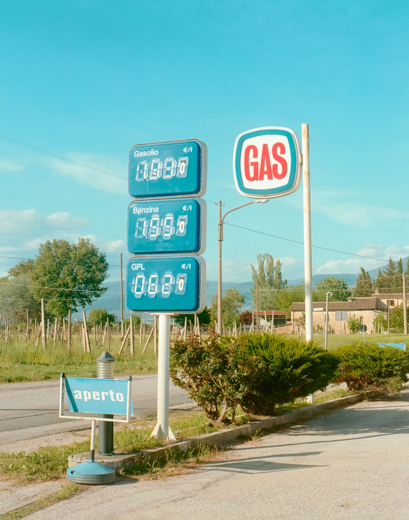 A blue gasoline sign with price information.