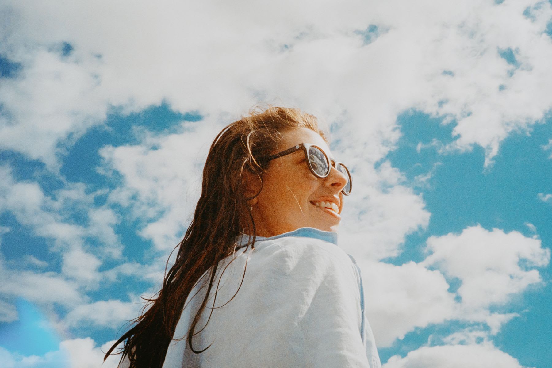 a woman standing next to a clear sky