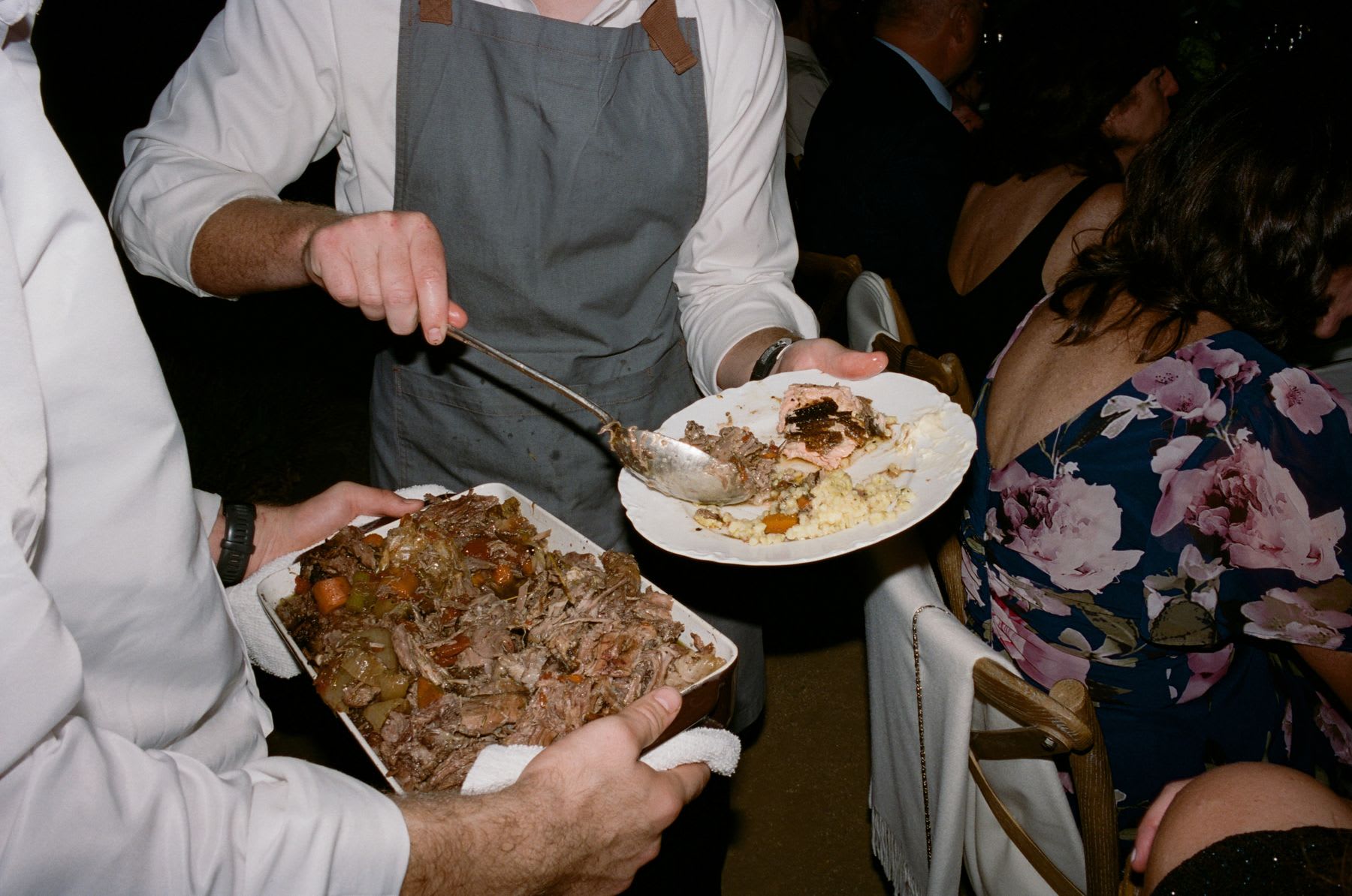 a person eating some food with others