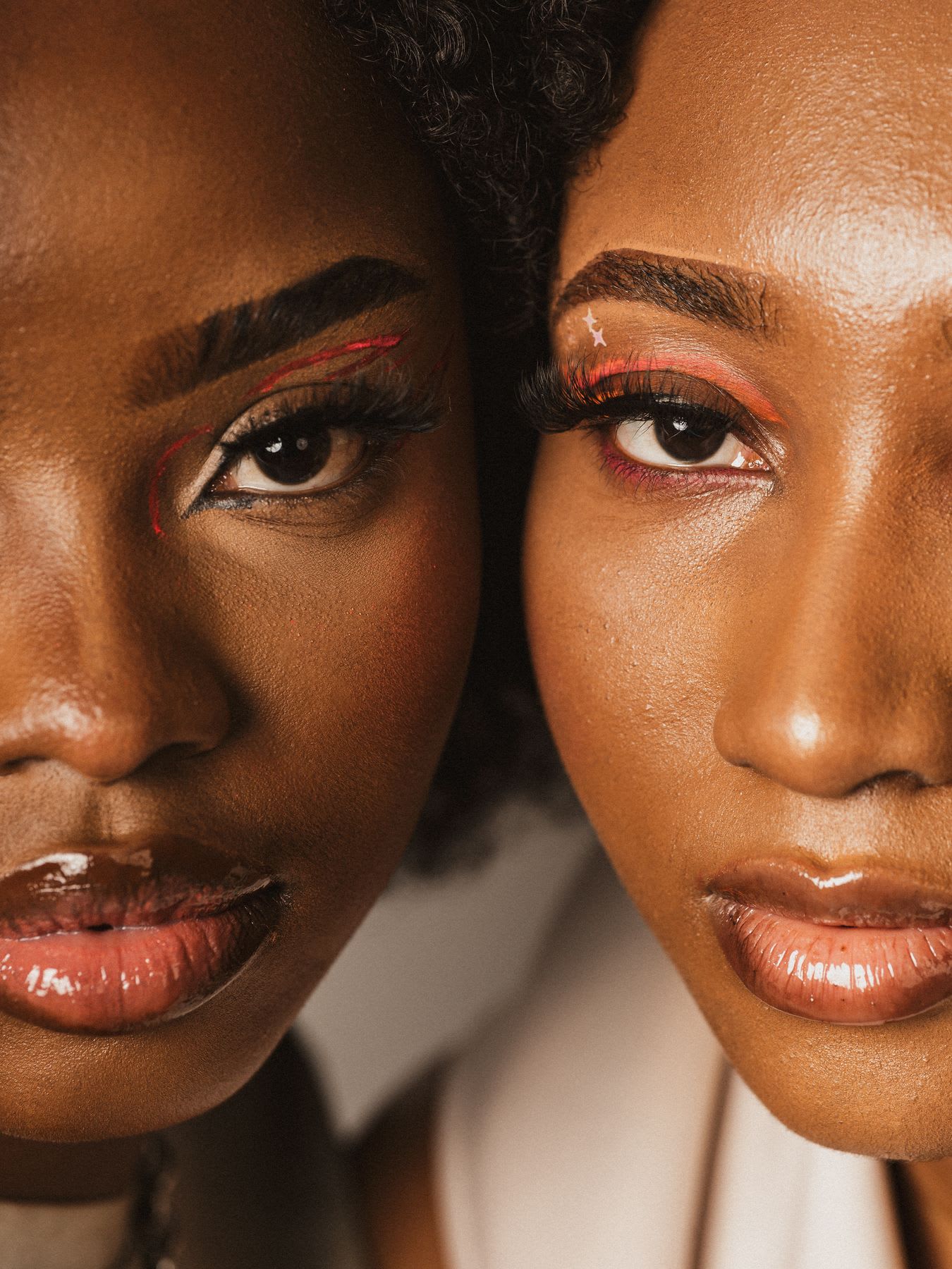 two women keep their faces expressionless as they pose