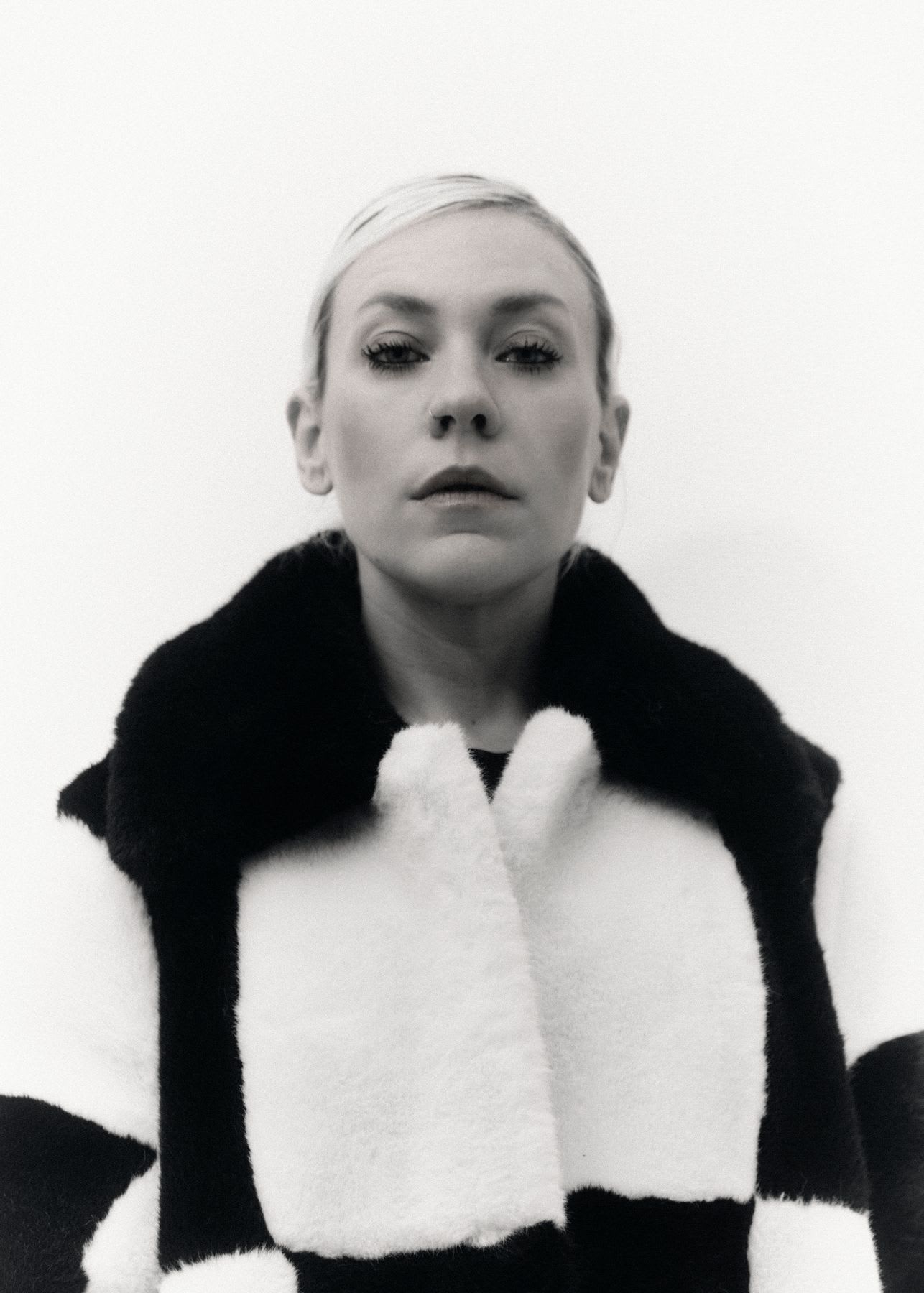 A woman wearing a fluffy sweater.