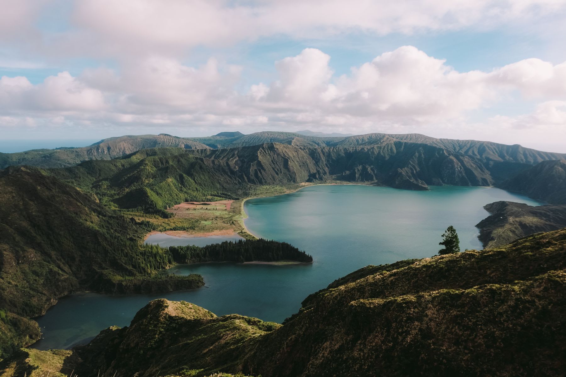 A view of a lake near the base of some hills