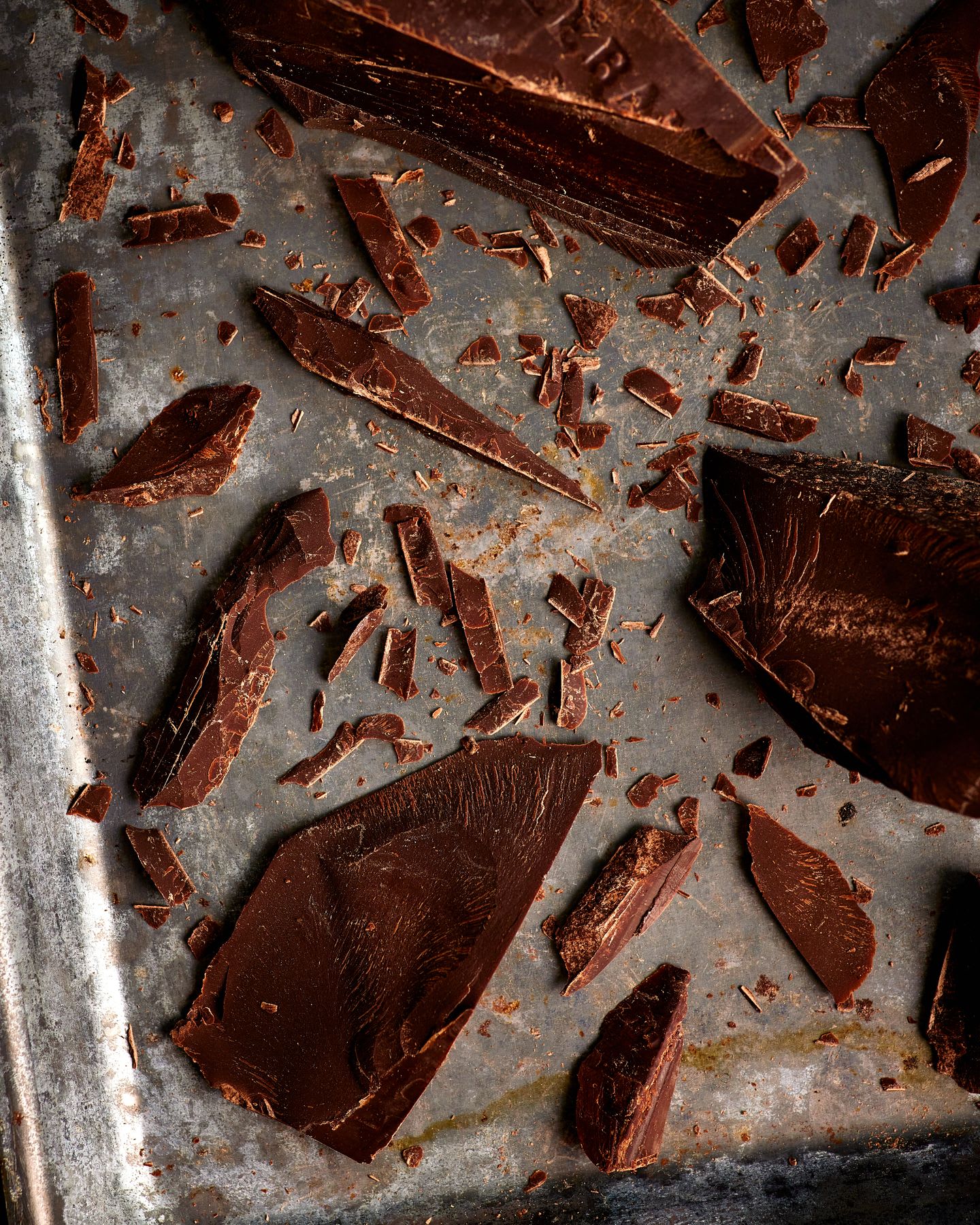 large pieces of chocolate are on a pan with some shards broken off