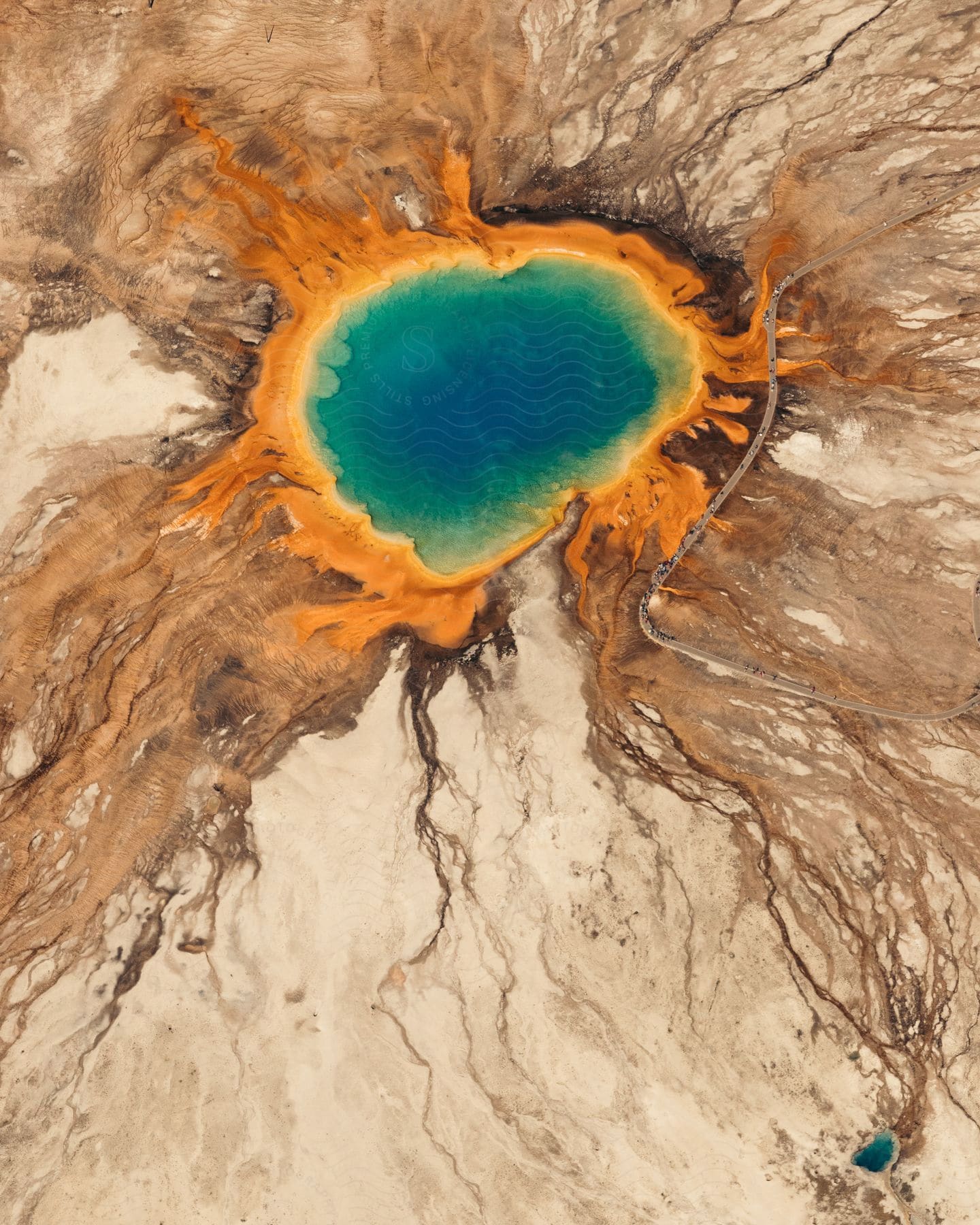 An aerial view of a lake that is colorful