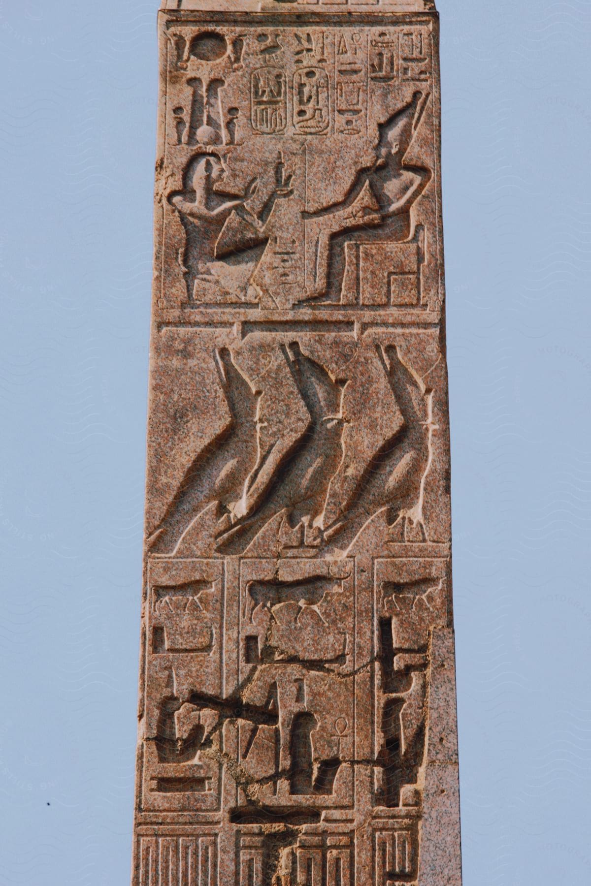 A stone pillar with carved hieroglyphs.