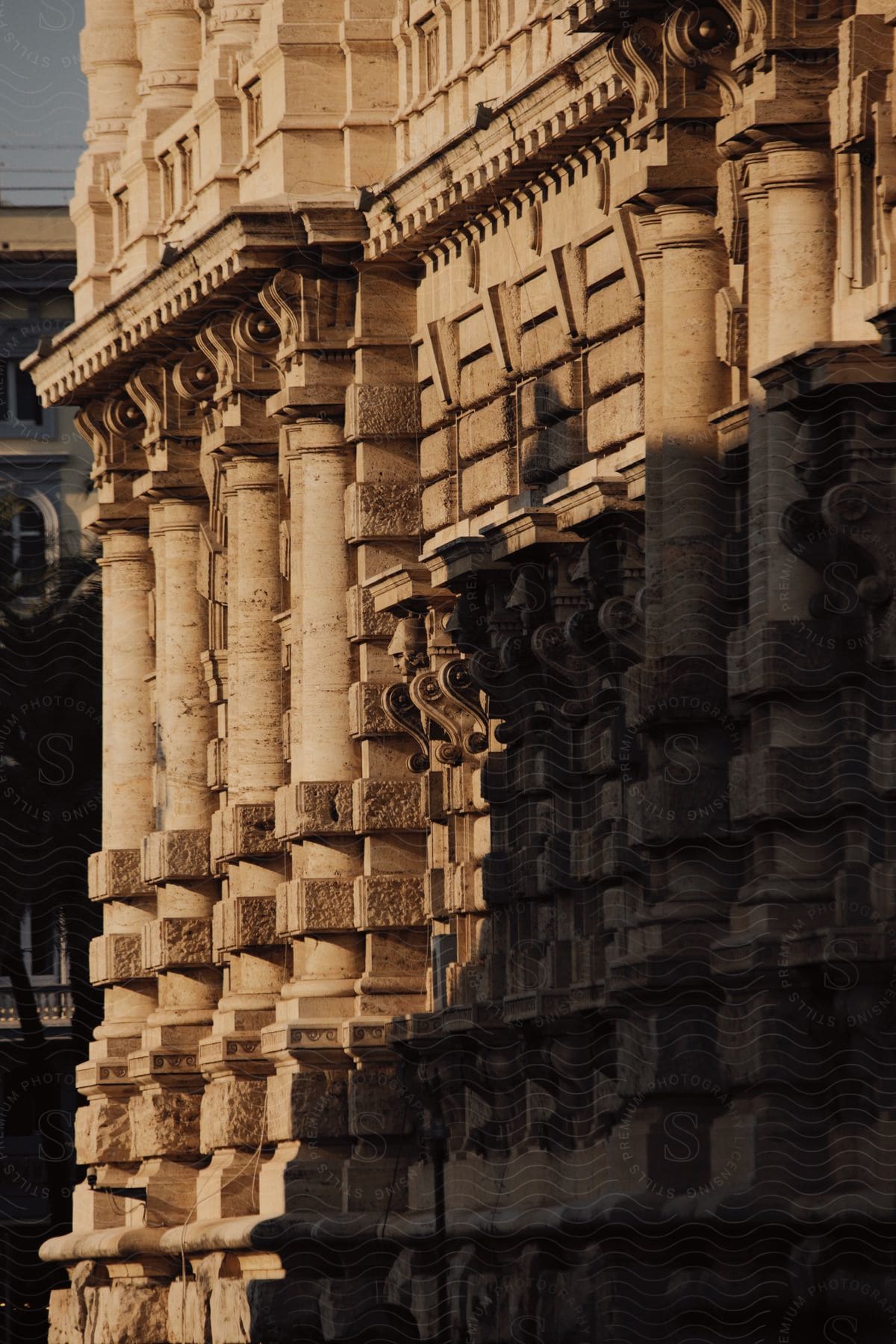 Landmark building with neoclassical architecture sits near street on a sunny day