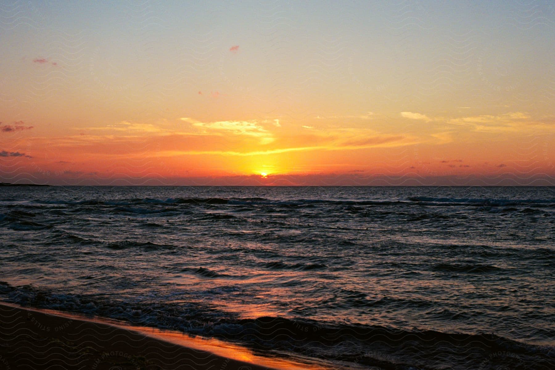 The sun setting in the distance over the ocean.