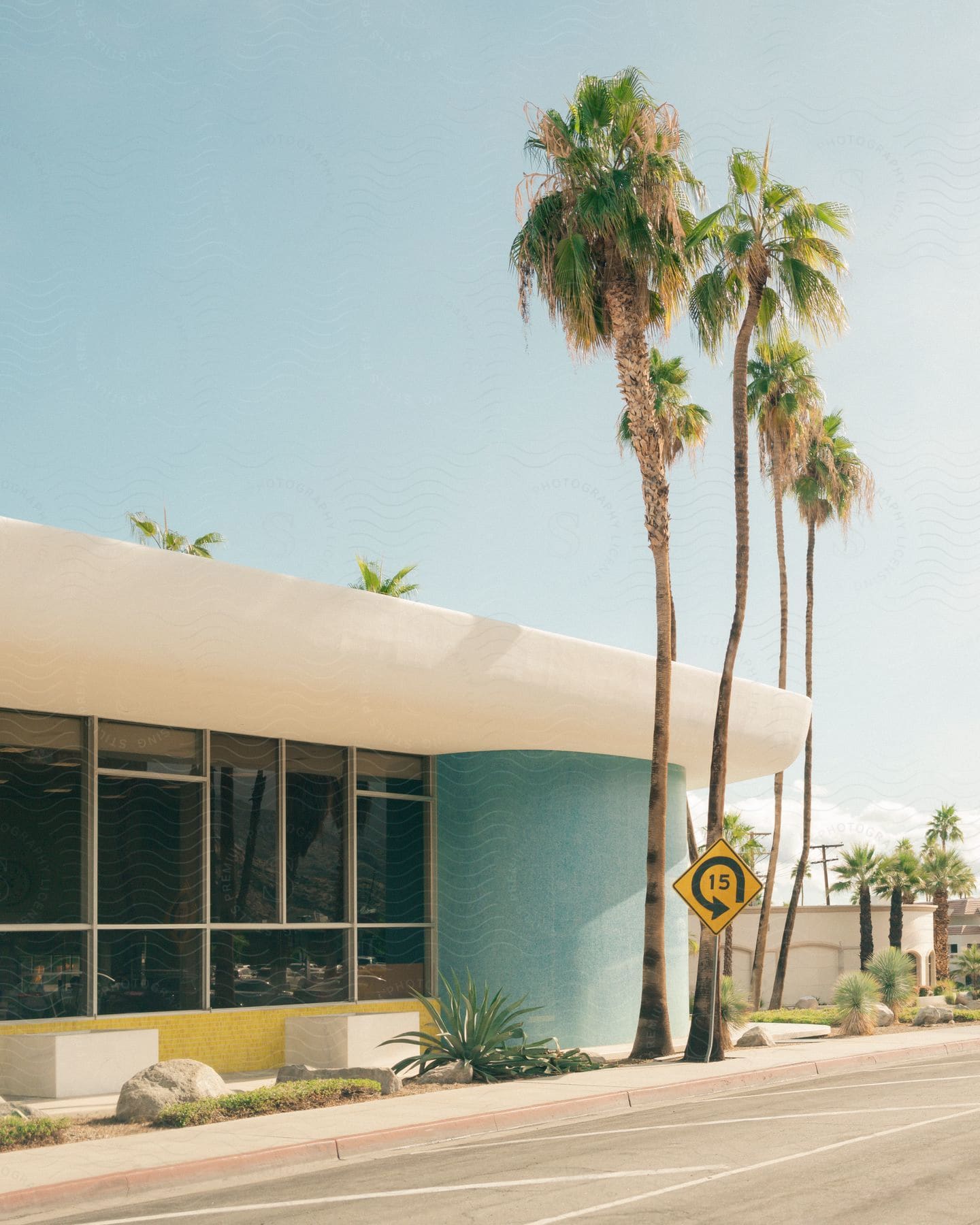 Palm trees, street sign and  building in Palm Springs