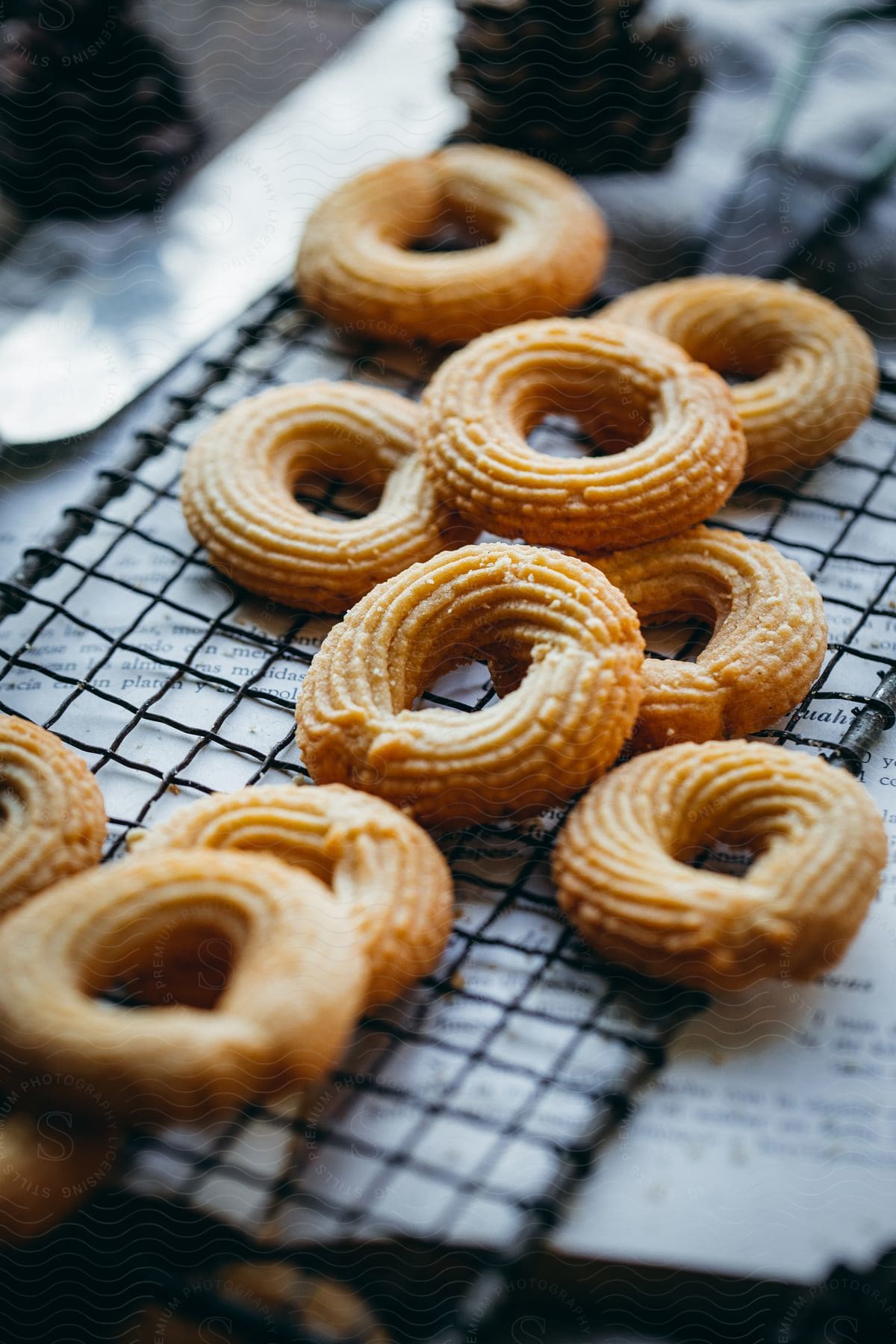 Pastries cool on mesh set on newspaper.