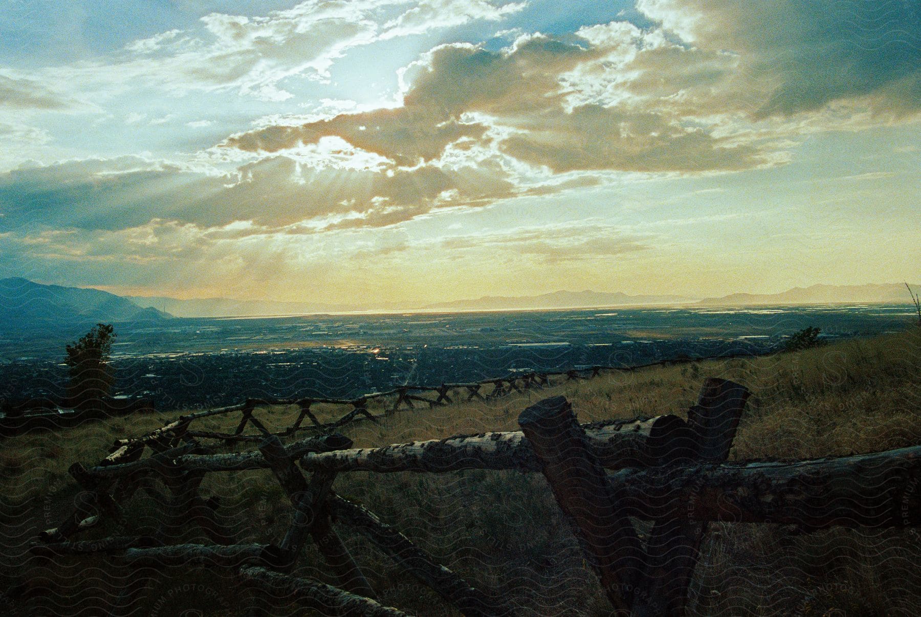 rustic wooden fence, grassland plains on cloudy day