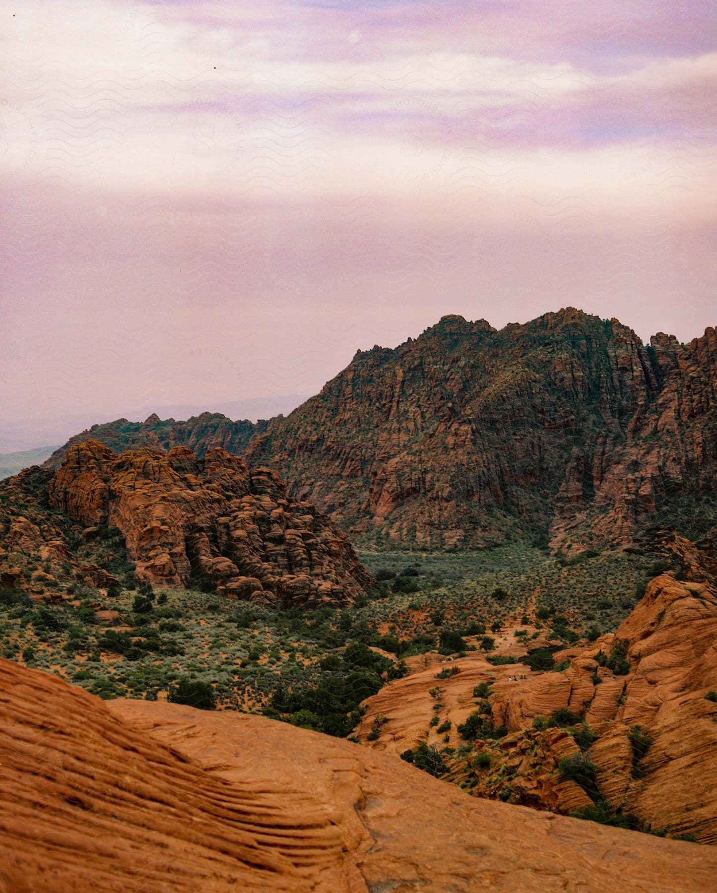 A view of mountains and sand in a desert.