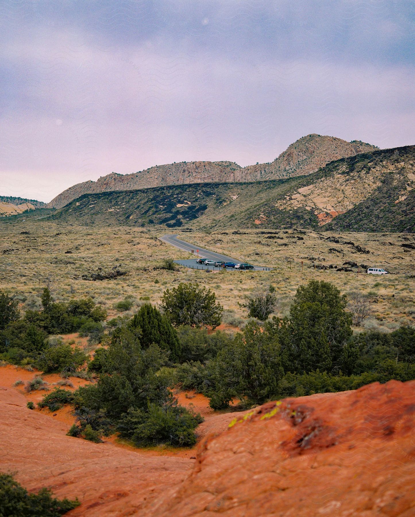 Cars parked next to the mountains at daytime