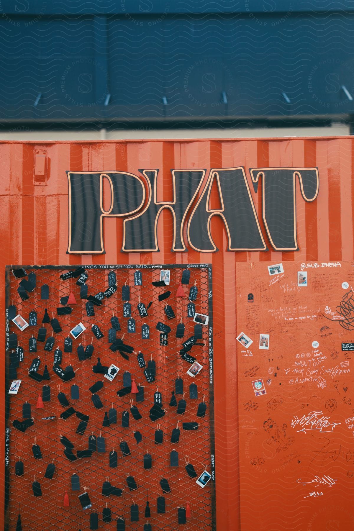 A red wall with a grid with stamps.