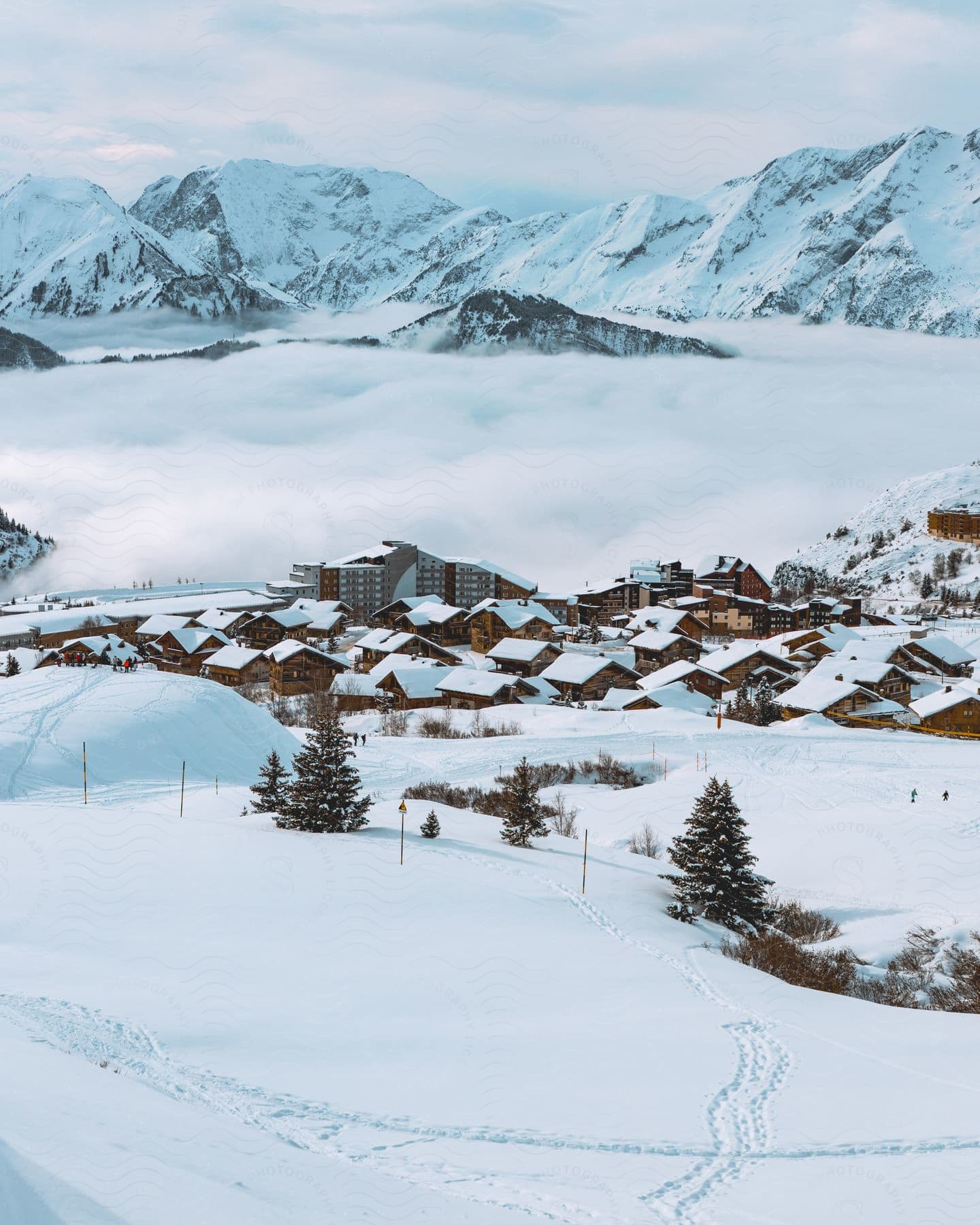 A snow covered a mountain valley village under a cloudy sky