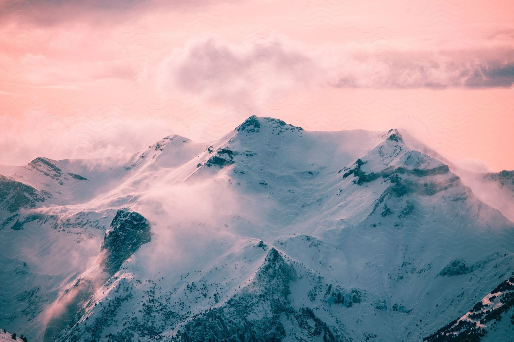 Majestic snowy mountain range bathed in the soft glow of dusk