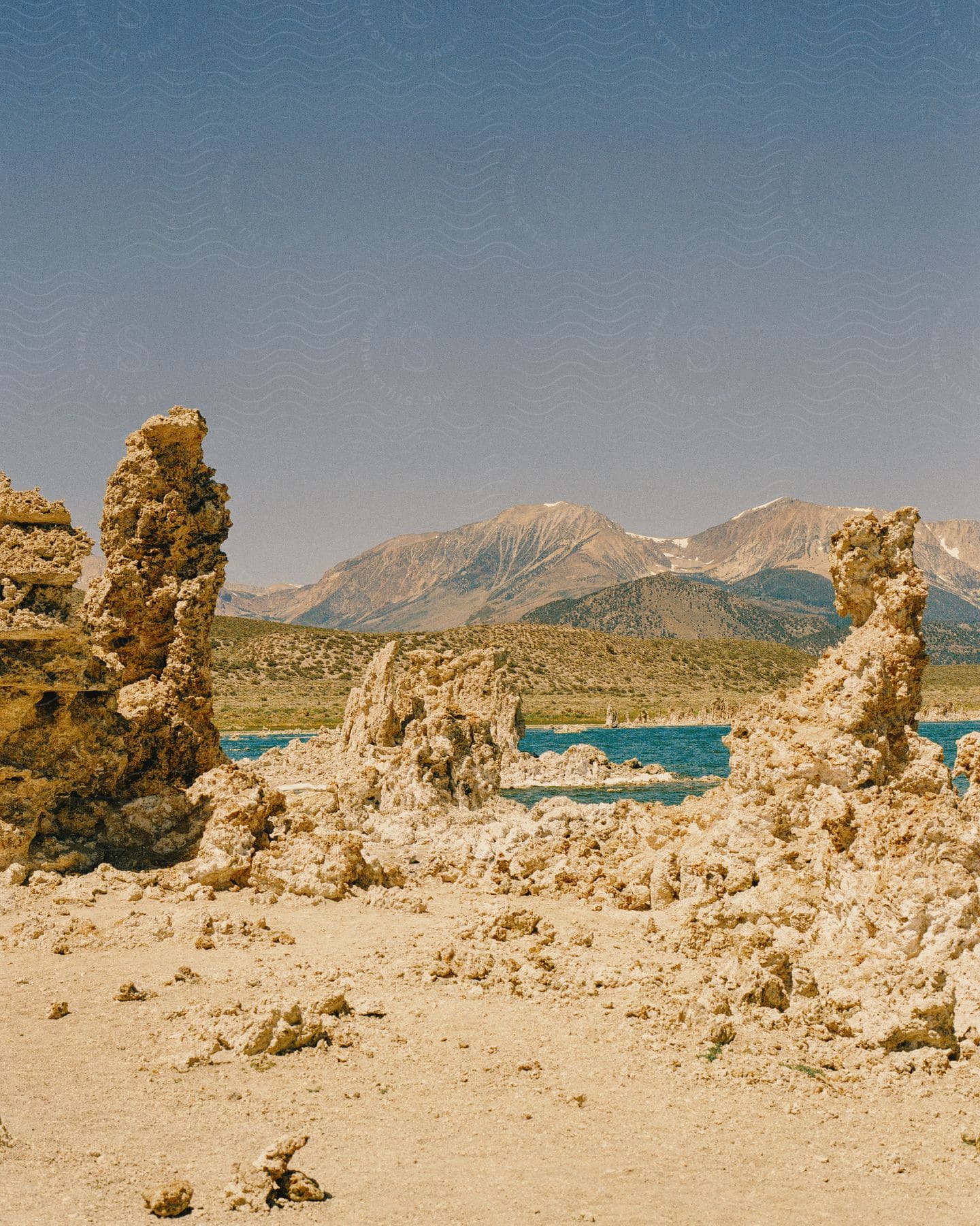 Rock formations on a lake next to the mountains