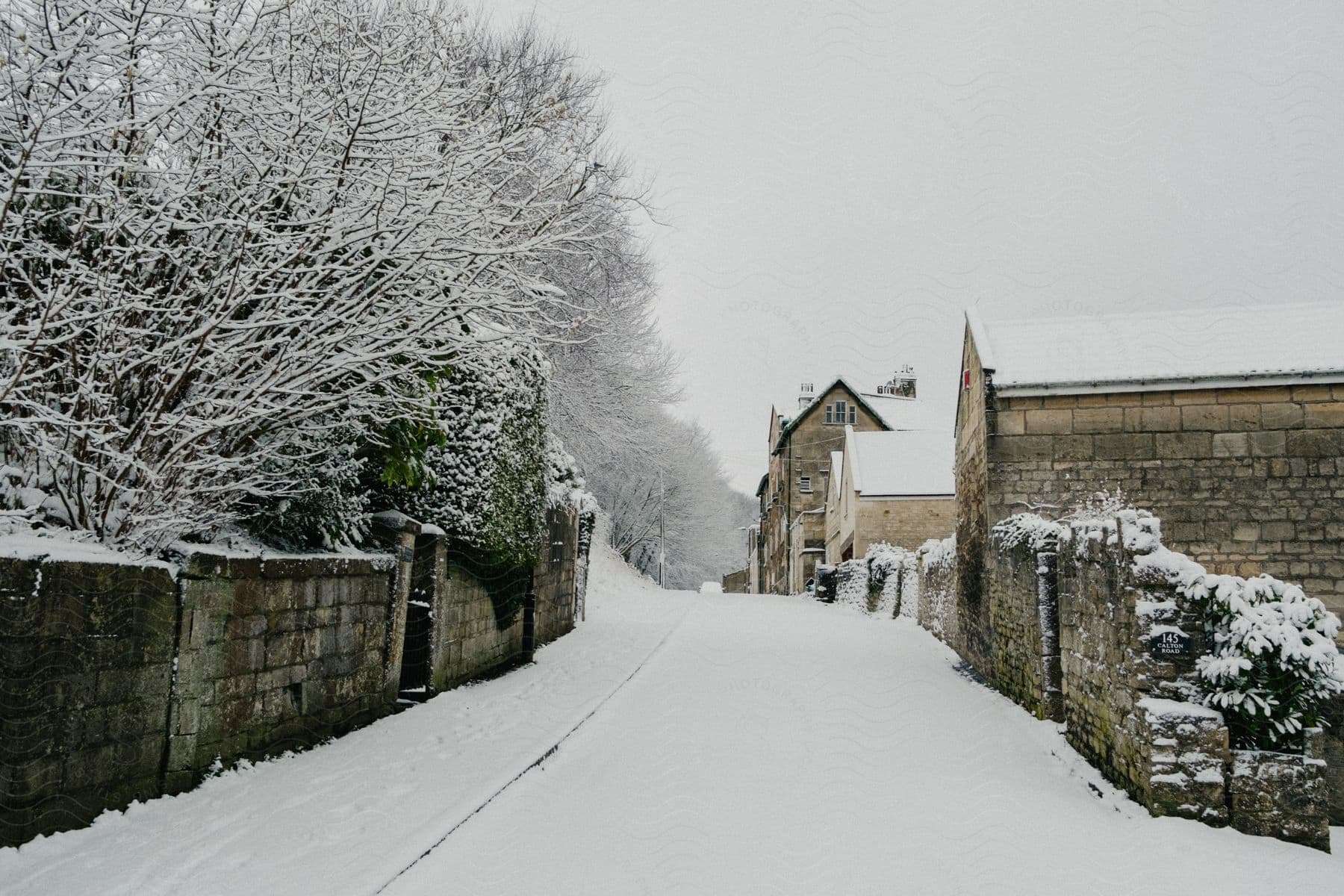 View of a street in a snow-covered residential neighborhood.