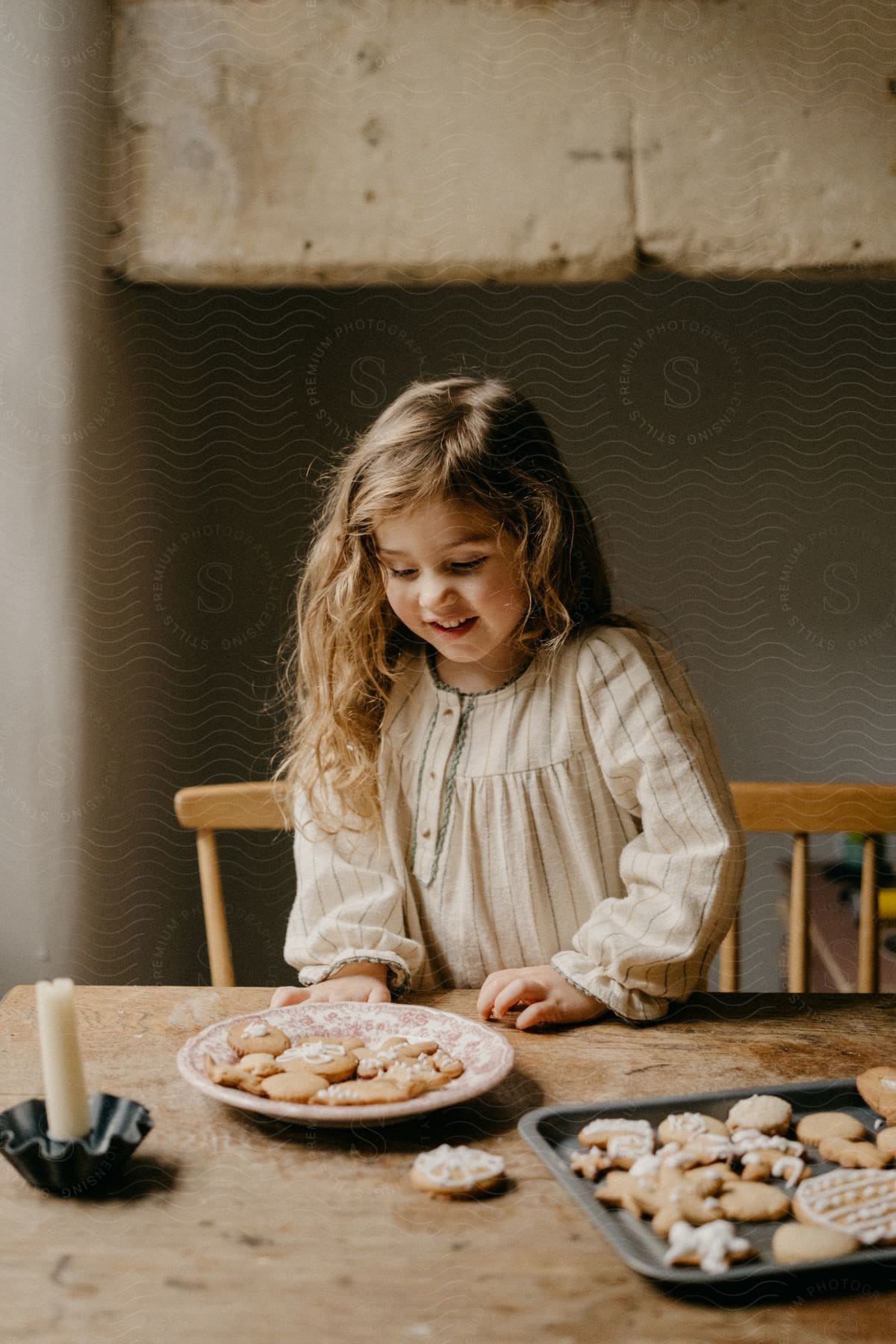 Happy girl looking at a plate full of freshly baked cookies