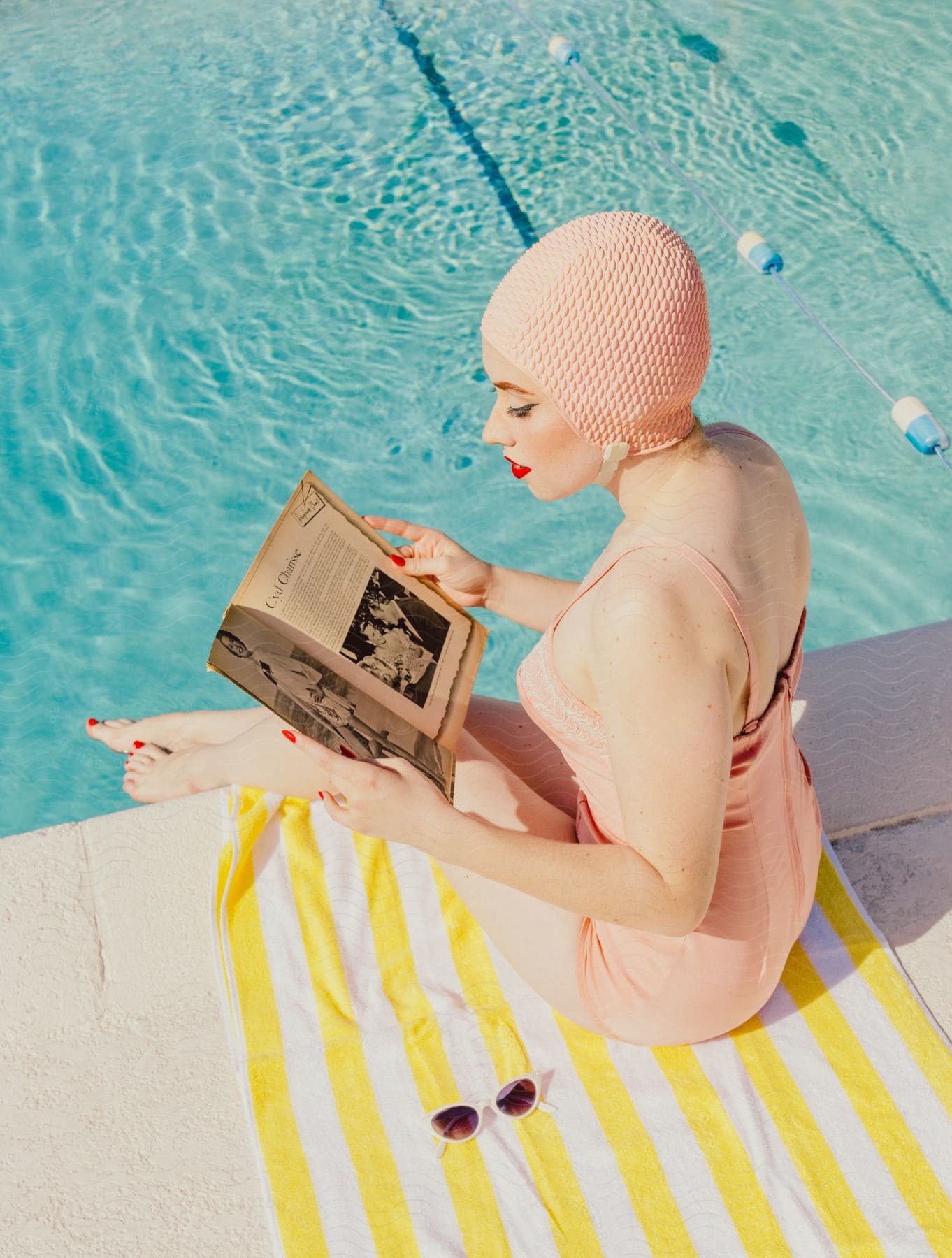 A woman modeling some classic swimwear next to a pool.