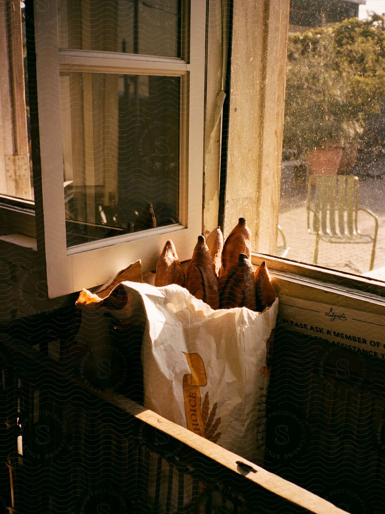 Bread in a bag near the window.