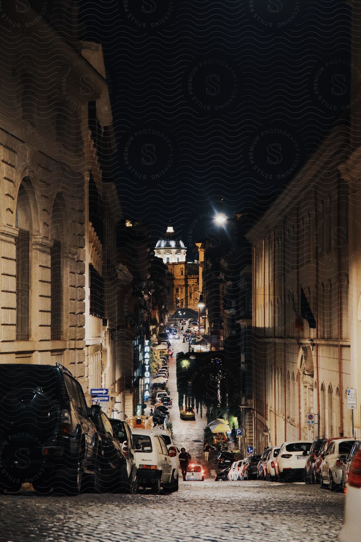 A street with parked cars and buildings with classic architecture.