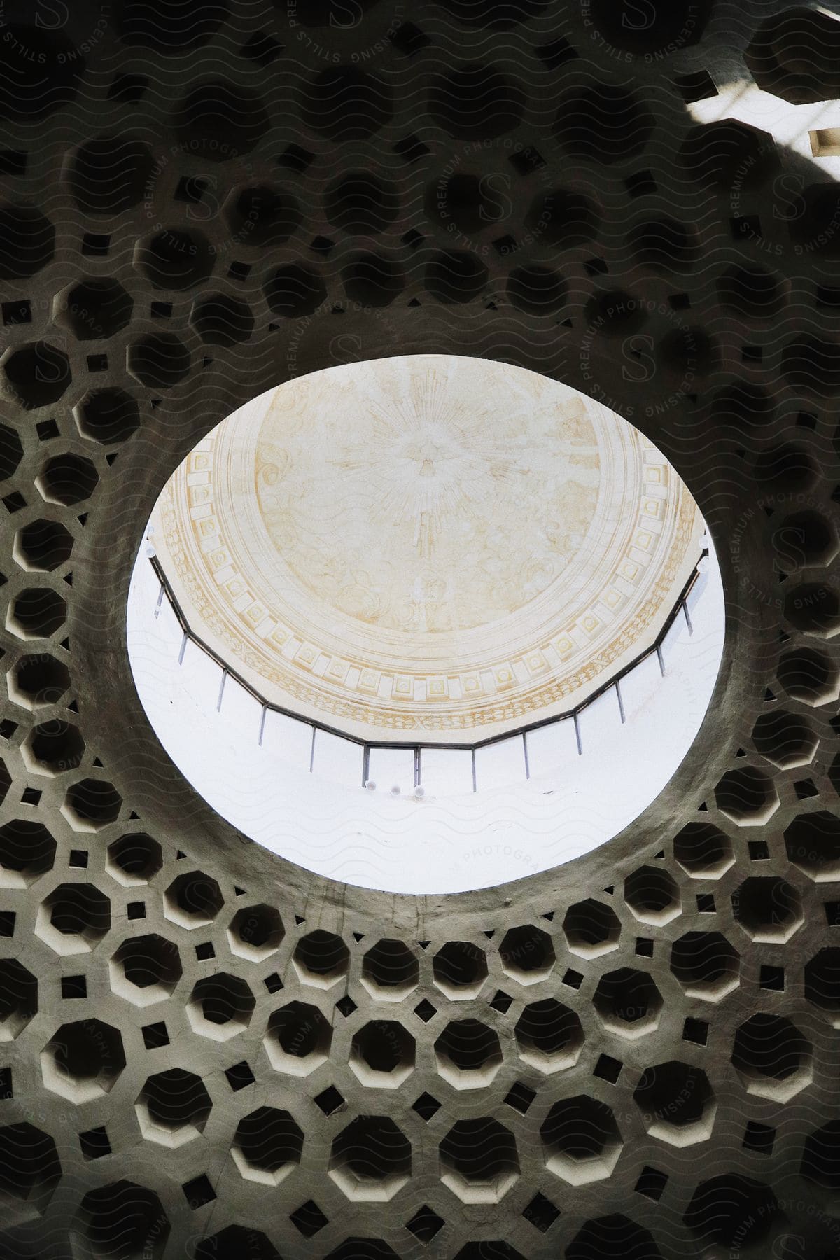 A dome in an ancient building with windows around the top of it.